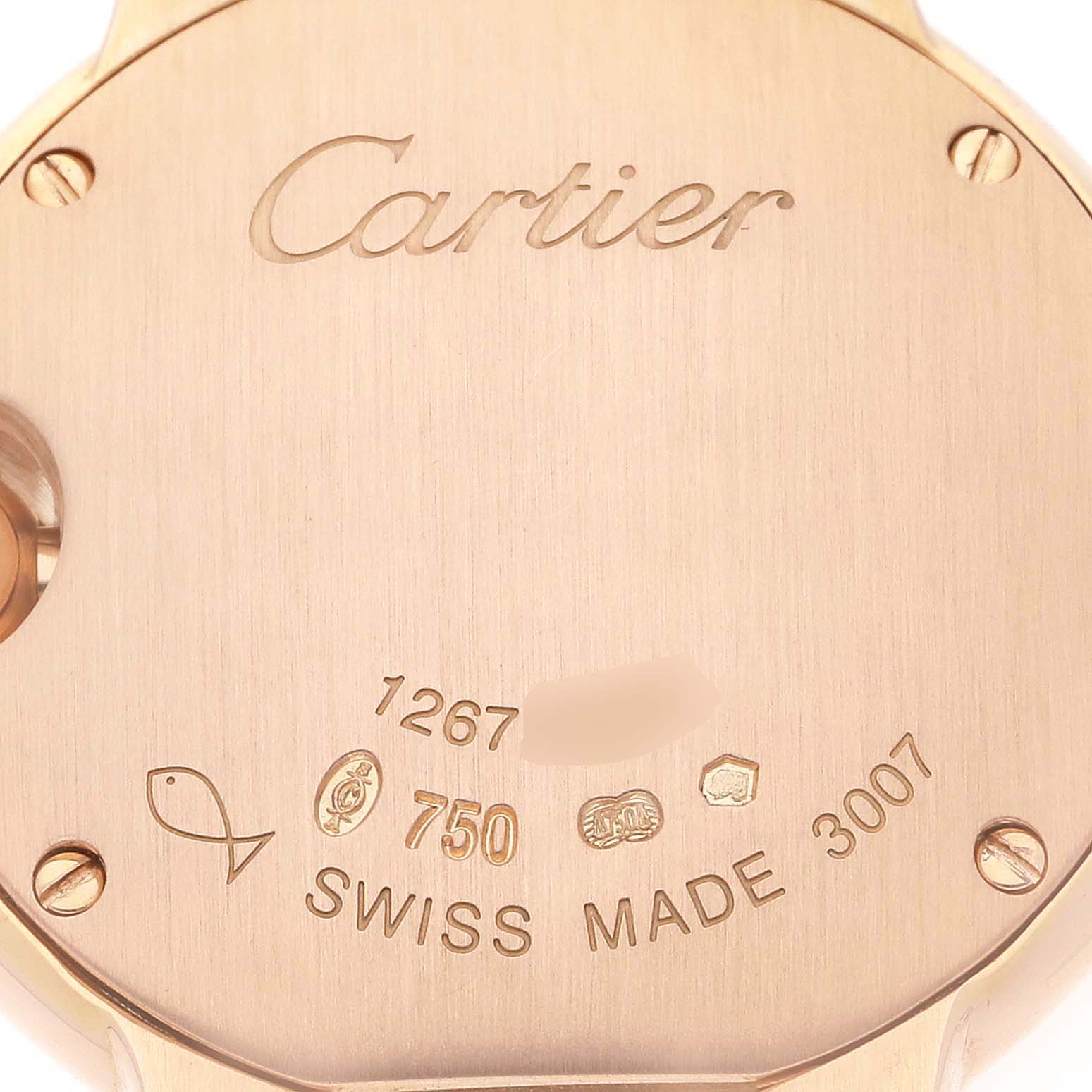 The image shows the back of a Ballon Bleu model watch by Cartier, highlighting the engraving and Swiss-made marking.