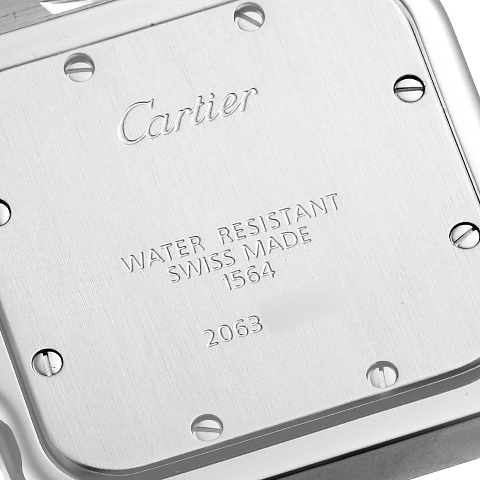 The image shows the back case of the Cartier Santos W20060D6 Men
s Stainless Steel Silver Dial W20060D6 Men
s Stainless Steel Silver Dial watch, focusing on the engraved details and screws.