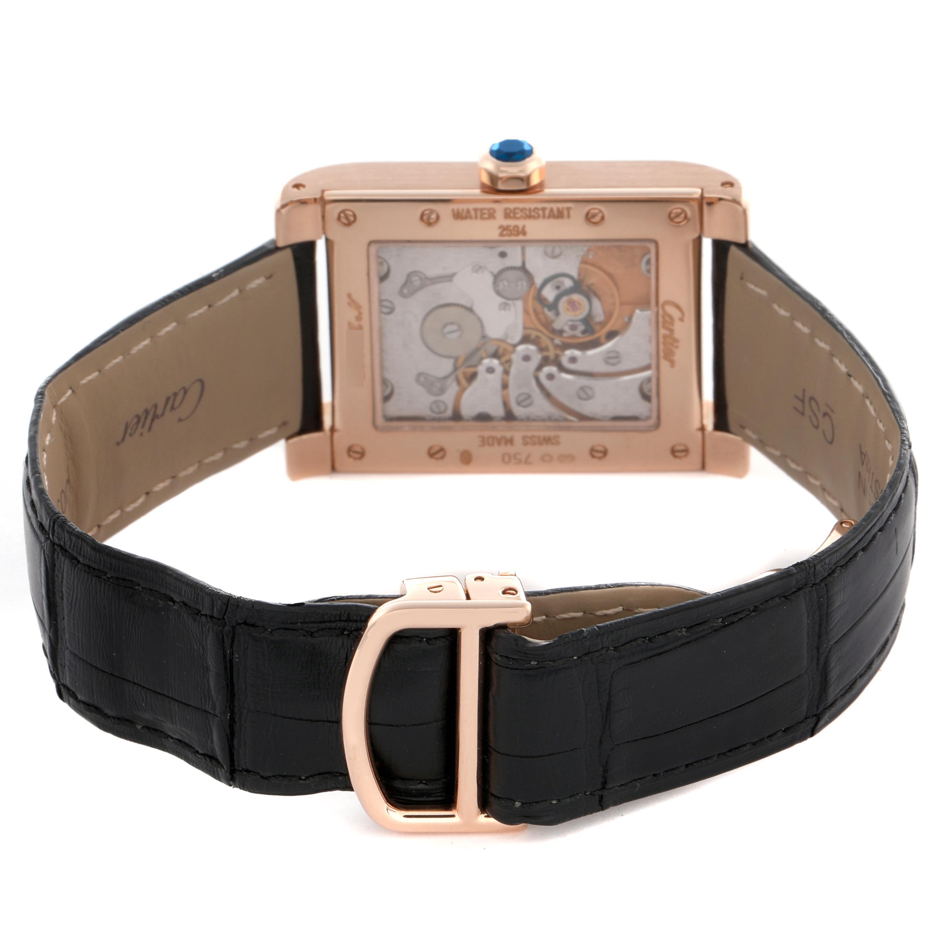 The Cartier Tank A Vis W1537651 Men's Rose Gold Silver Dial W1537651 Men's Rose Gold Silver Dial watch is shown from the back, displaying its mechanical movement and leather strap with a buckle.