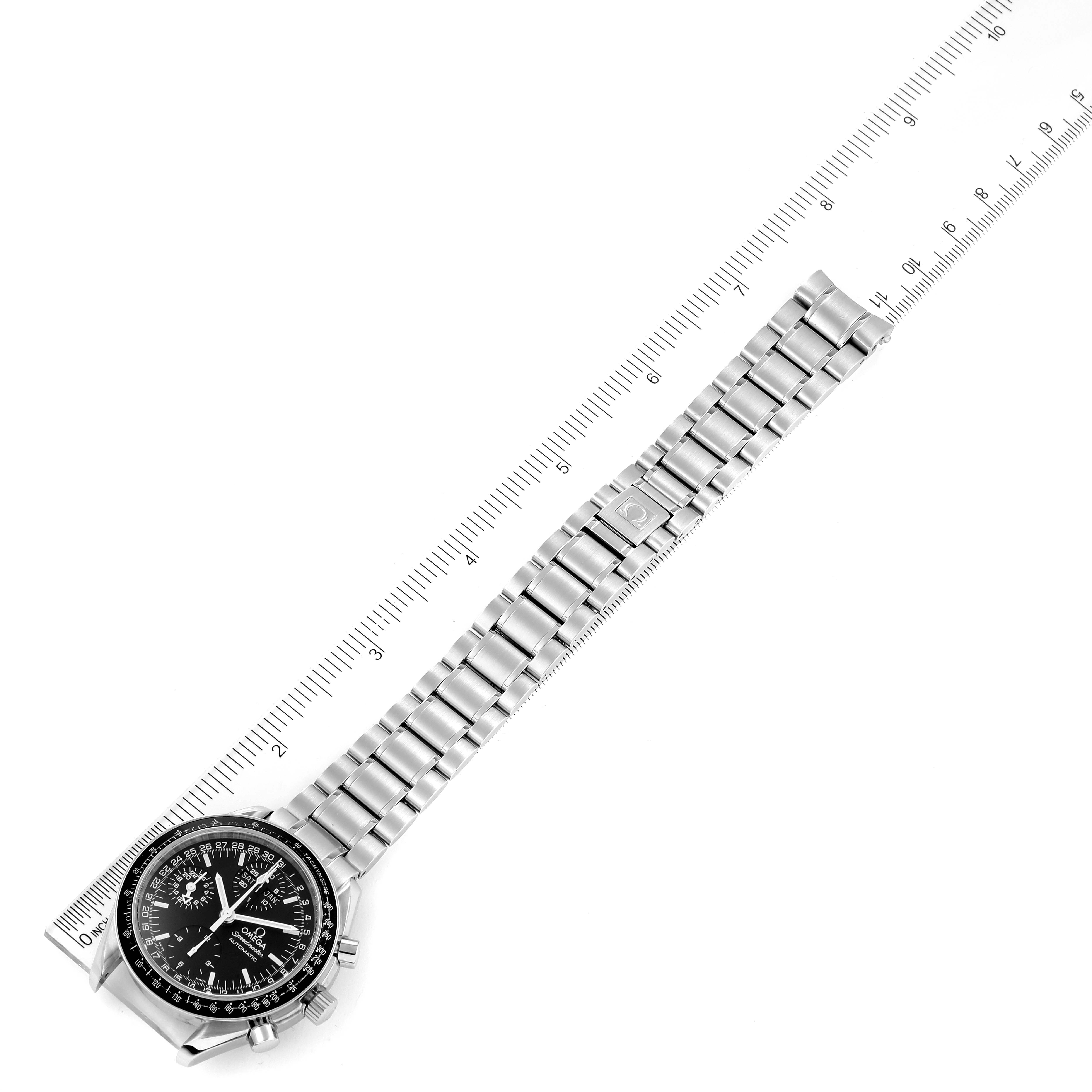 The Omega Speedmaster 3520.50.00 Men
s Stainless Steel Black Dial 3520.50.00 Men
s Stainless Steel Black Dial watch is shown at a slight angle with its face, bezel, and metal bracelet displayed next to a ruler.