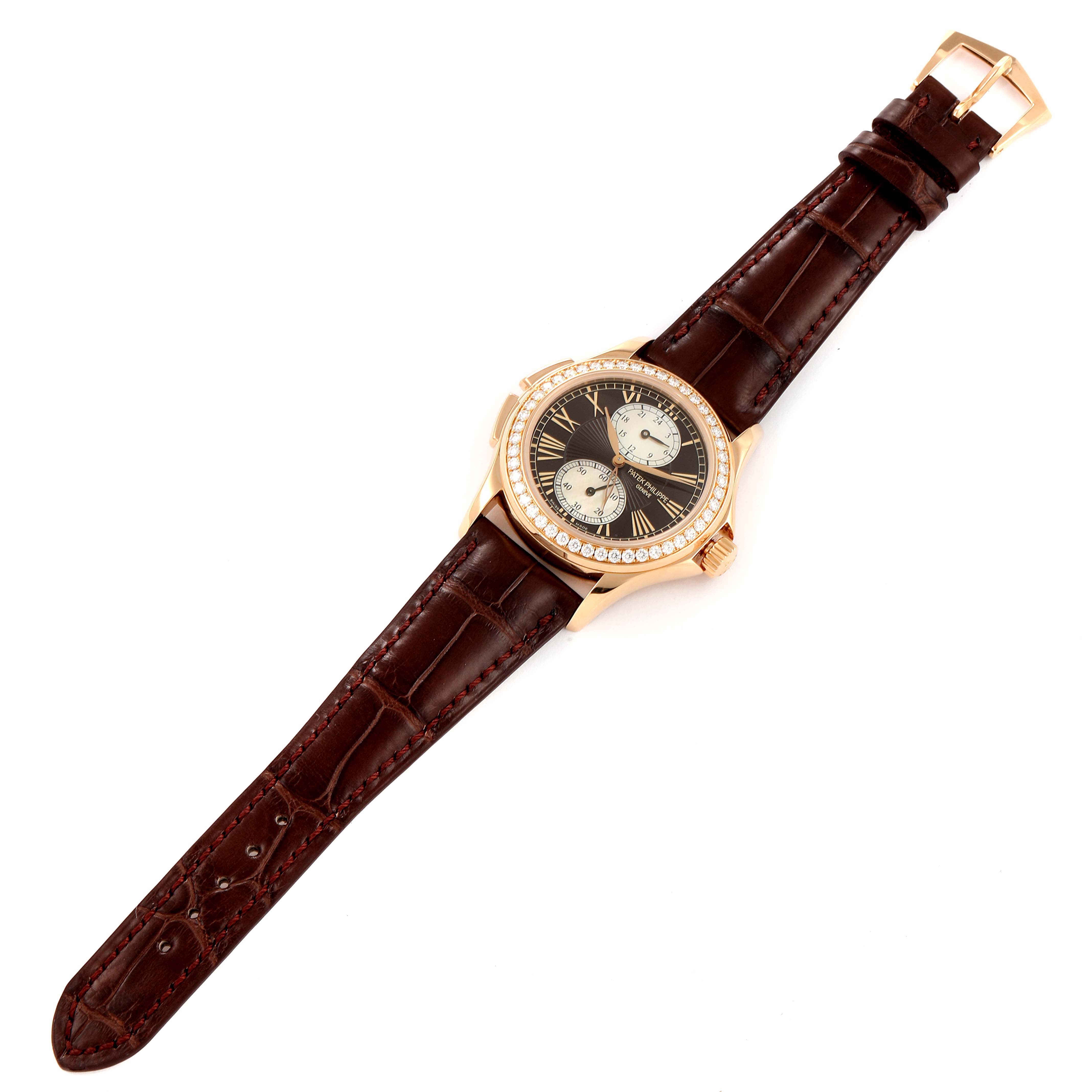 The Patek Philippe Calatrava 4934R Men's Rose Gold Mother of Pearl Dial 4934R Men's Rose Gold Mother of Pearl Dial watch is shown from a top-down angle, displaying the entire watch including its dial, case, and leather strap.