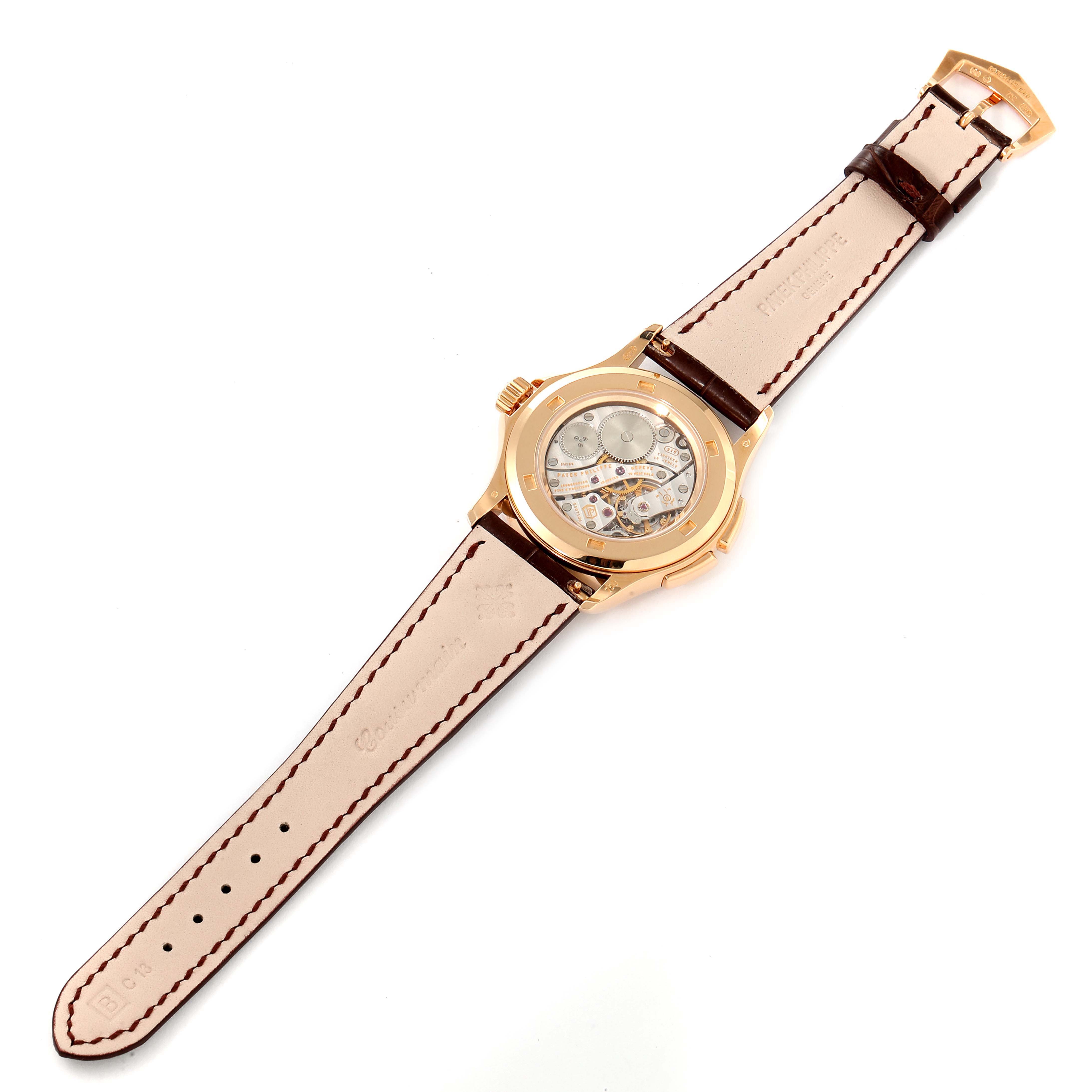 The Patek Philippe Calatrava 4934R Men's Rose Gold Mother of Pearl Dial 4934R Men's Rose Gold Mother of Pearl Dial watch is shown from the back, displaying its movement and leather strap.