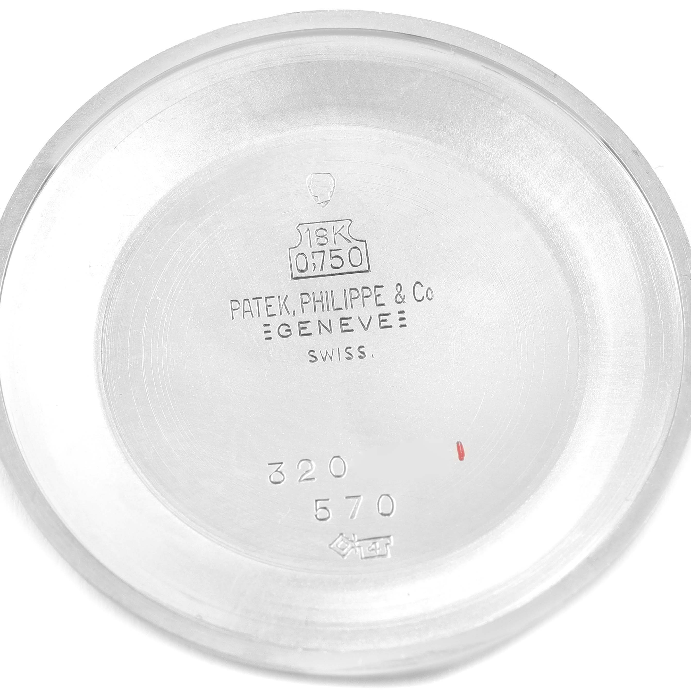 This image shows the inside case back of a vintage Patek Philippe 18K watch, highlighting the inscriptions and hallmarks.