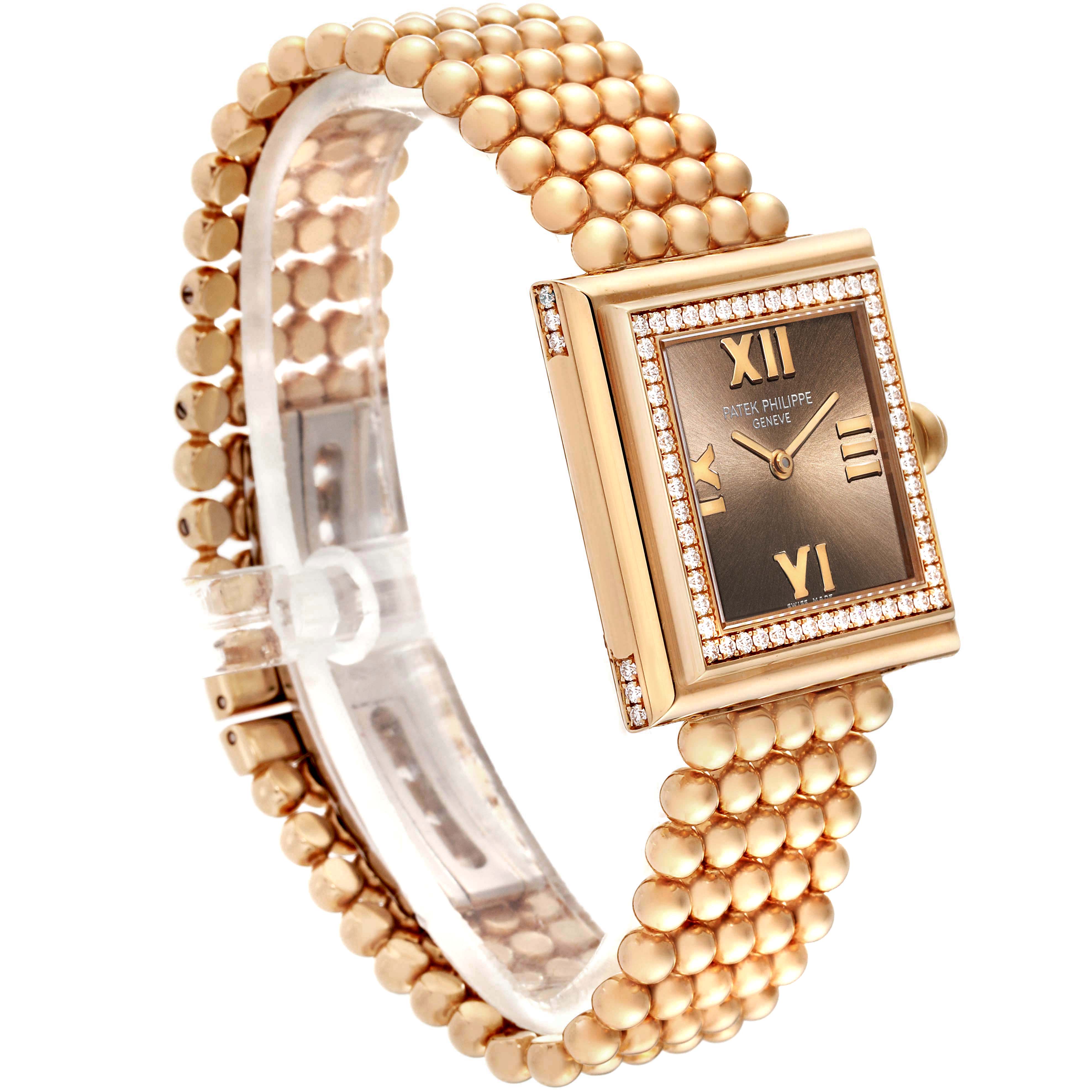 This image shows a side angle view of the Patek Philippe Gondolo 4868/1R-010 Women's Rose Gold Brown Dial 4868/1R-010 Women's Rose Gold Brown Dial watch, highlighting its gold case, beaded bracelet, and rectangular dial.