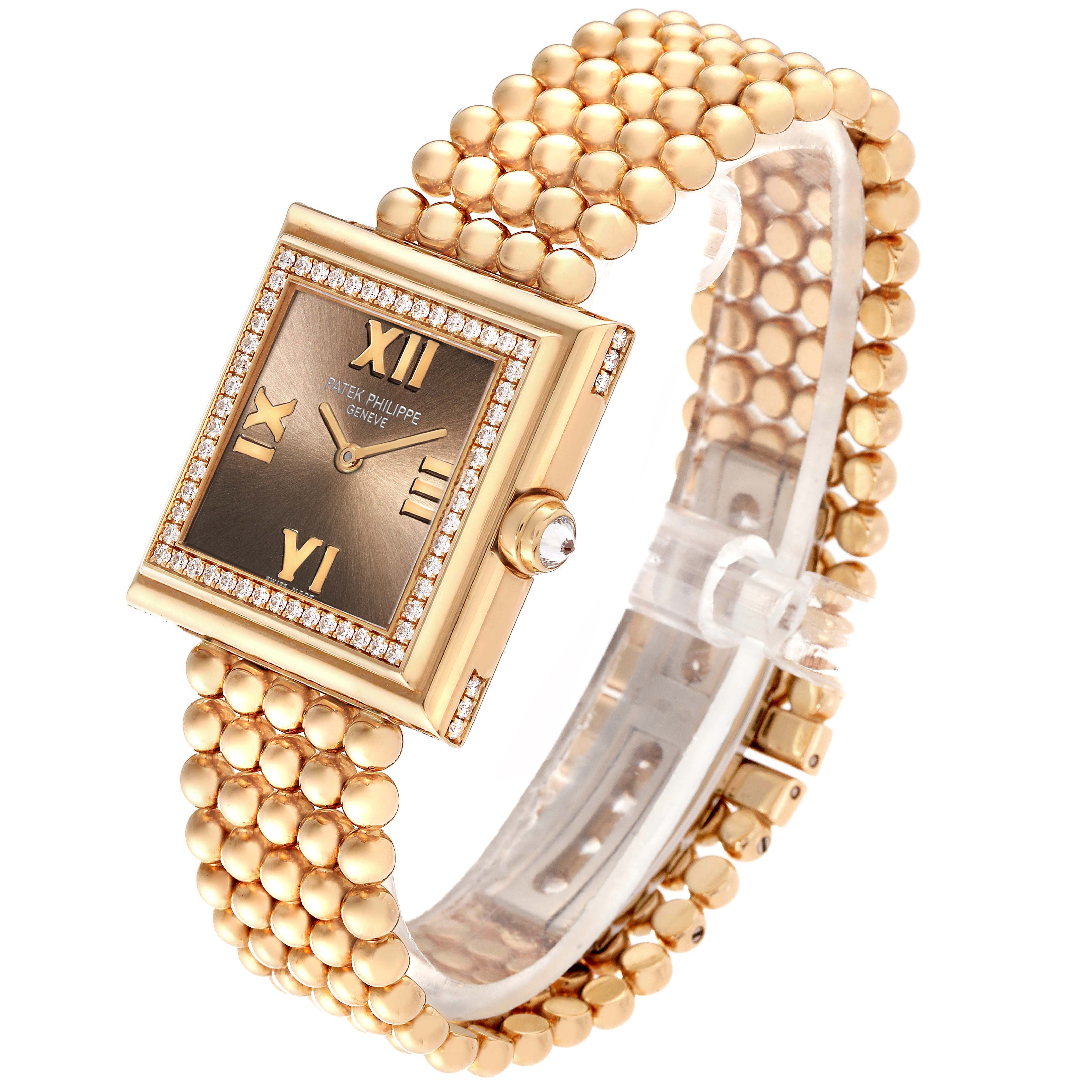 The image shows a side angle of a Patek Philippe Gondolo 4868/1R-010 Women's Rose Gold Brown Dial 4868/1R-010 Women's Rose Gold Brown Dial watch, highlighting its square face, gold bracelet, and diamond accents.