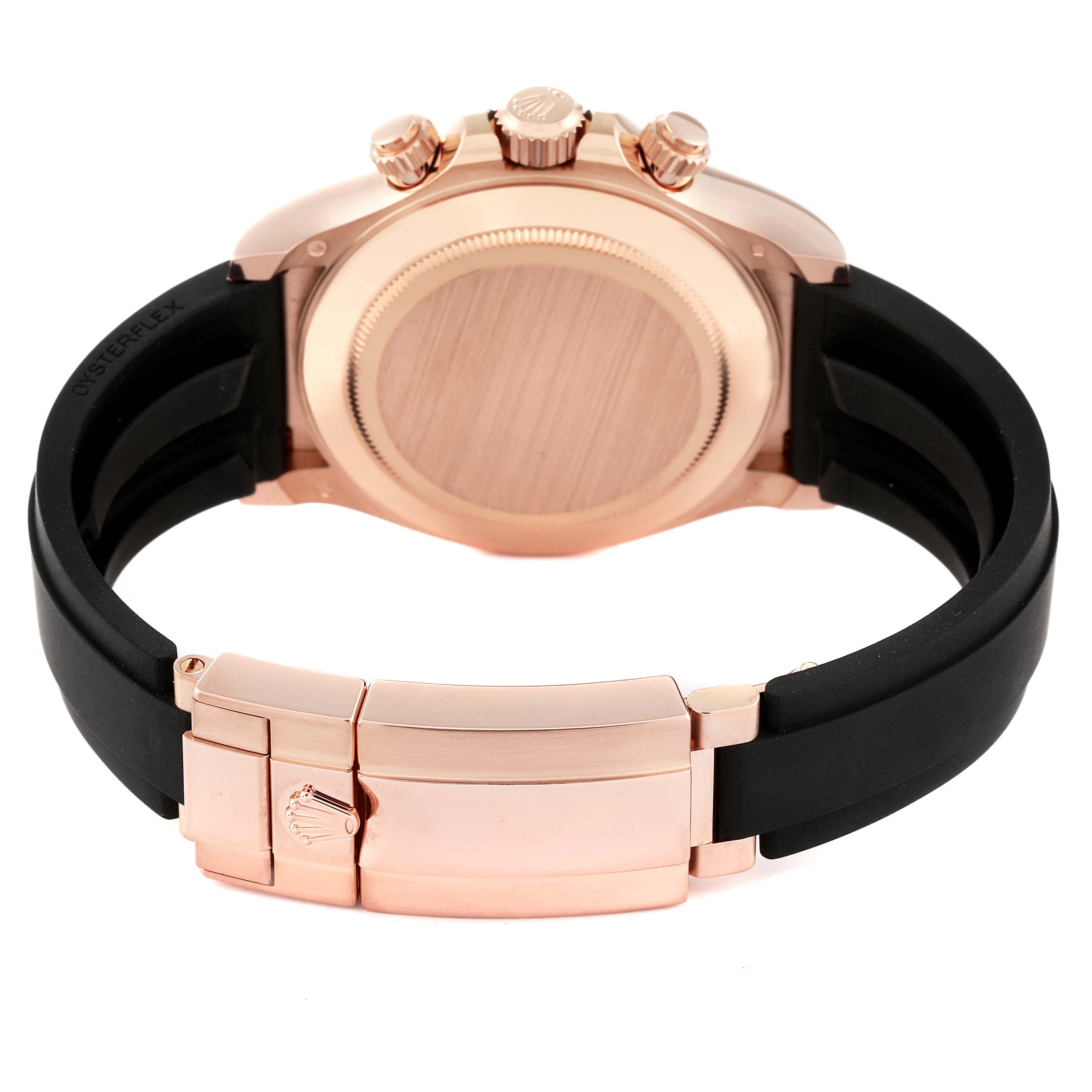 The image shows the back view of a Rolex Daytona 116515 Men's Rose Gold Brown Dial 116515 Men's Rose Gold Brown Dial watch, focusing on its case and the clasp of its black strap.