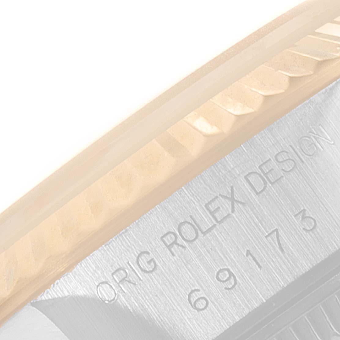 The image shows a close-up of the bezel and casing edge of a Rolex Datejust 69173 Women
s Steel and Gold (two tone) Champagne Dial 69173 Women
s Steel and Gold (two tone) Champagne Dial watch, displaying the "Orig Rolex Design" engraving with the model number 69173.