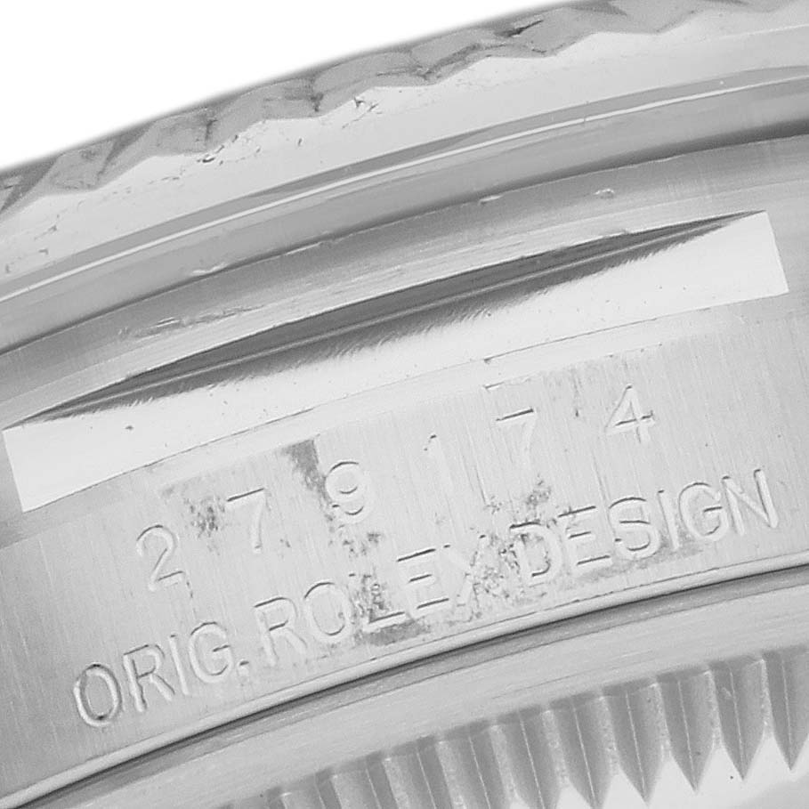 This image shows a close-up of the engraved inner bezel and part of the fluted bezel of a Rolex Datejust 279174 Women's Stainless Steel Grey Dial 279174 Women's Stainless Steel Grey Dial watch.