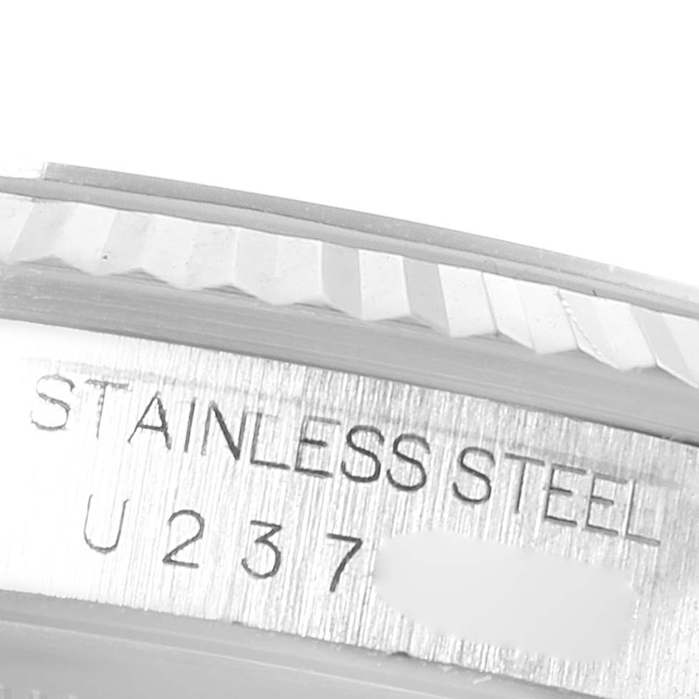 The image shows a close-up of the stainless steel bezel with the serial number of a Rolex Datejust 16234 Men's Stainless Steel Blue Dial 16234 Men's Stainless Steel Blue Dial watch.