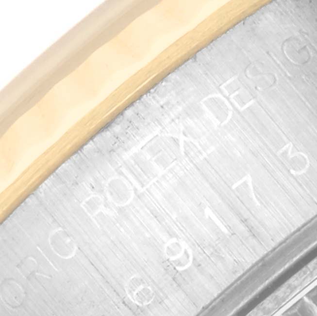 The image shows a close-up of the engraving on the side of a Rolex Datejust 69173 Women's Steel and Gold (two tone) Champagne Dial 69173 Women's Steel and Gold (two tone) Champagne Dial watch case, featuring the brand name and model information.