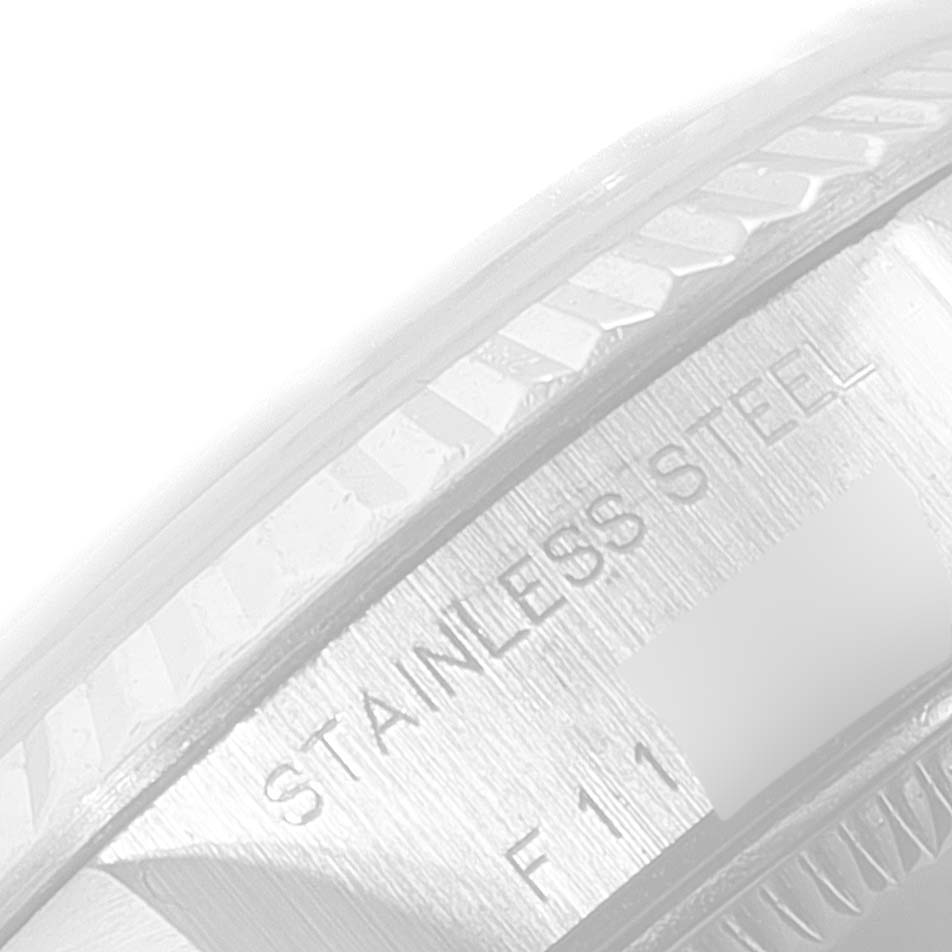 The image shows a close-up of the stainless steel bezel and side engraving of the Rolex Datejust 79174 Women's Stainless Steel Blue Dial 79174 Women's Stainless Steel Blue Dial watch.