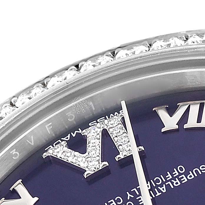 This close-up image of a Rolex Mid-Size 178384 Women's Stainless Steel Purple Dial 178384 Women's Stainless Steel Purple Dial watch shows part of the bezel, diamond-set numerals, and a portion of the dial.