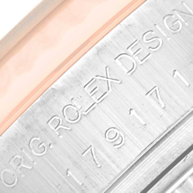 The image shows a close-up of the engraved side of a Rolex Datejust 179171 Women's Steel and Gold (two tone) Silver Dial 179171 Women's Steel and Gold (two tone) Silver Dial watch, including part of the serial number and "ROLEX DESIGN" text.