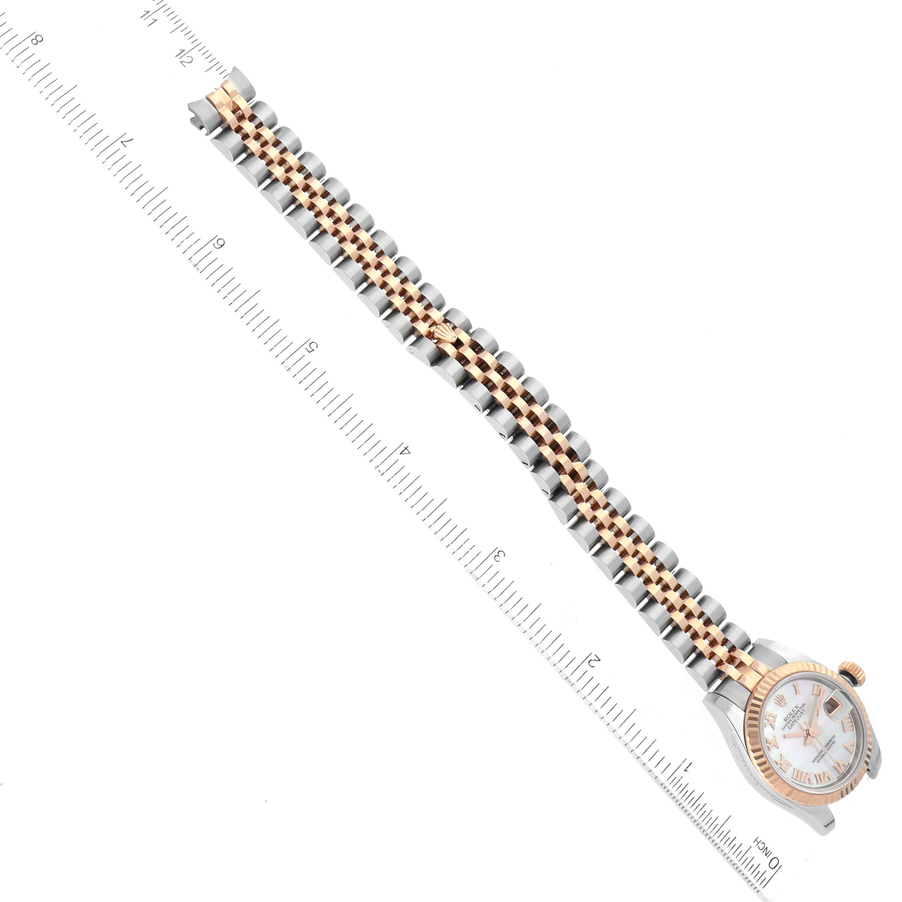 The image shows a Rolex Datejust 179171 Women's Steel and Gold (two tone) Mother of Pearl Dial 179171 Women's Steel and Gold (two tone) Mother of Pearl Dial watch from the top, displaying the watch face and the full length of its metal bracelet with a ruler for scale.