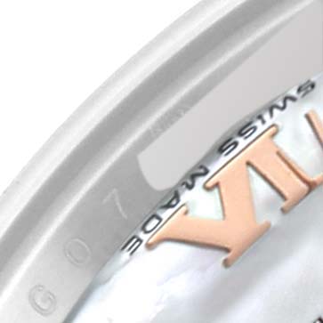 This close-up shows the edge of the dial and the bezel of a Rolex Datejust 179171 Women's Steel and Gold (two tone) Mother of Pearl Dial 179171 Women's Steel and Gold (two tone) Mother of Pearl Dial watch with part of the Roman numeral "XII."