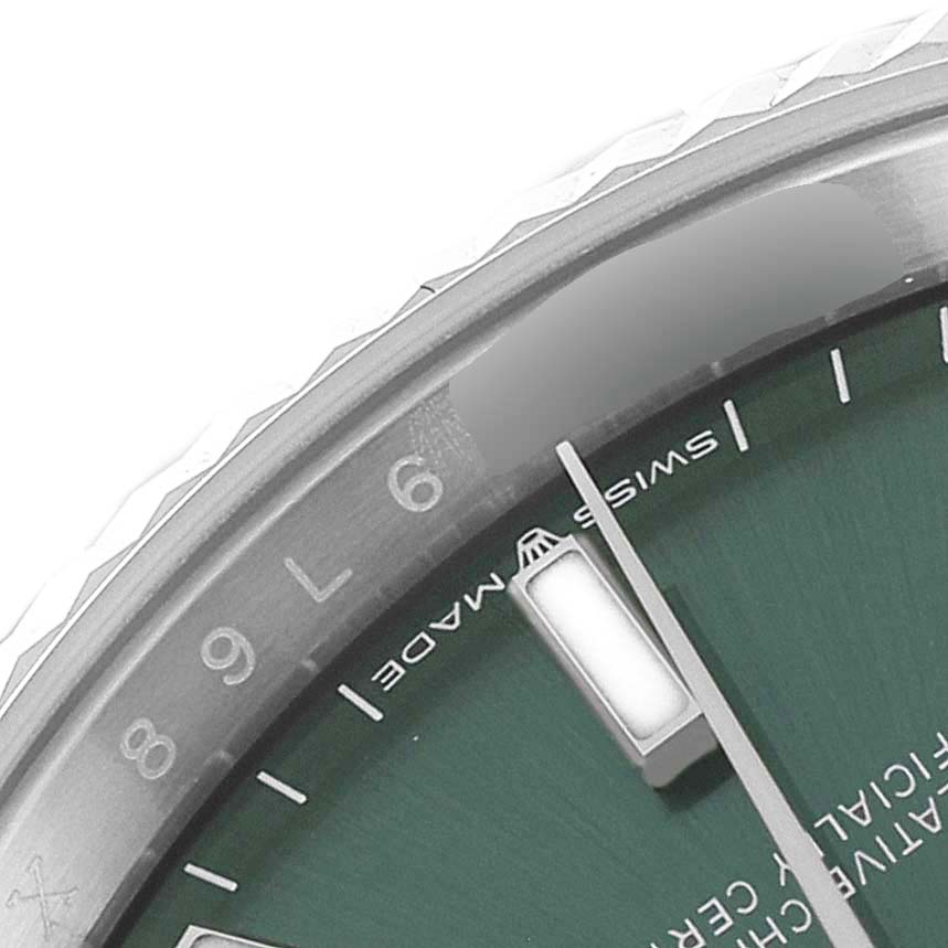 The image shows a close-up of the Rolex Datejust 126234 Men's Stainless Steel Green Dial 126234 Men's Stainless Steel Green Dial watch, focusing on a portion of its green dial, bezel, and "SWISS MADE" inscription.