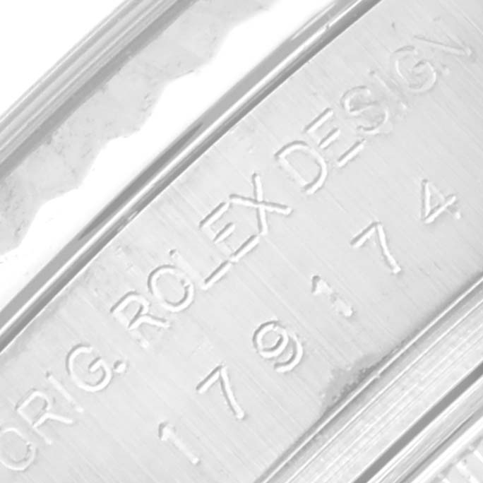 The image shows a close-up of the engraving on the side of a Rolex Datejust 179174 Women's Stainless Steel Mother of Pearl Dial 179174 Women's Stainless Steel Mother of Pearl Dial watch with inscriptions "ROLEX DESIGN."