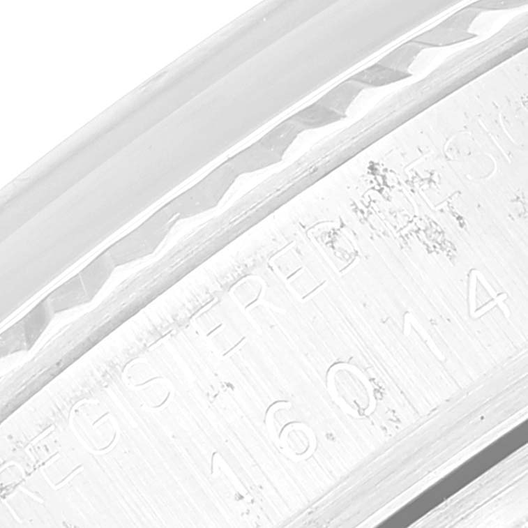 The close-up image shows an engraved part of the bezel and case of the Rolex Vintage Collection 16014 Men's Stainless Steel Silver Dial 16014 Men's Stainless Steel Silver Dial watch.