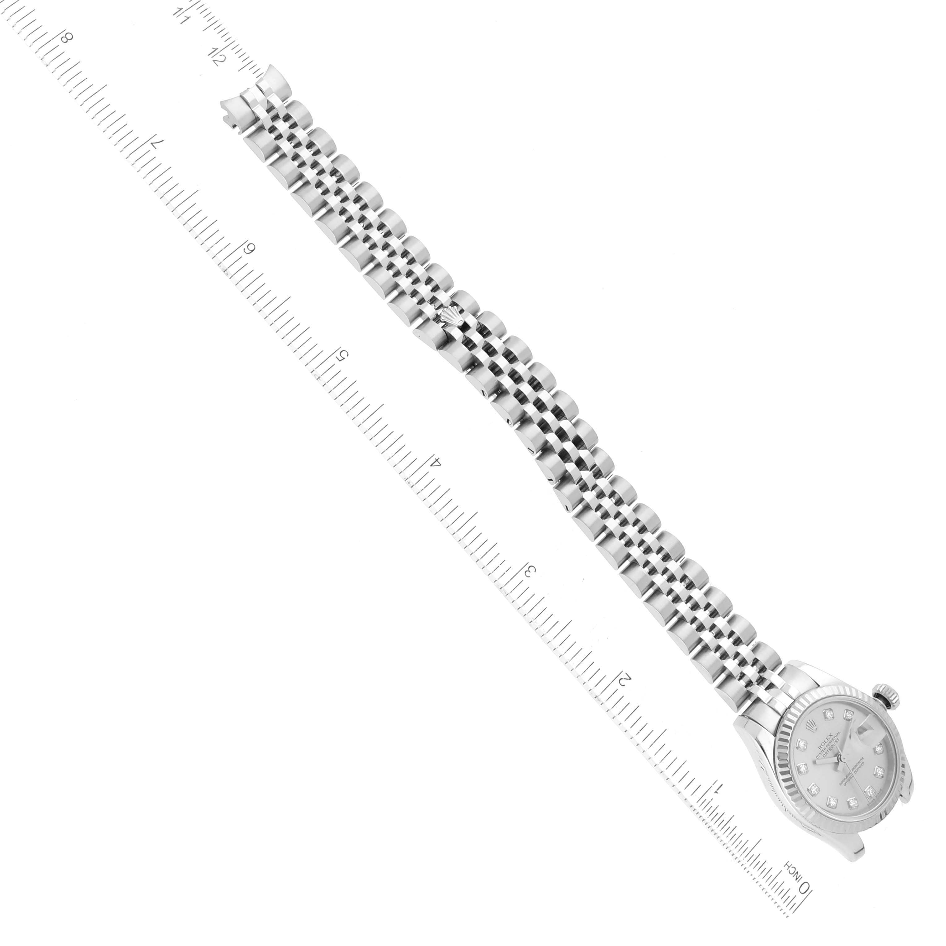 The image shows a Rolex Datejust 179174 Women's Stainless Steel Silver Dial 179174 Women's Stainless Steel Silver Dial watch lying flat, with its face and Jubilee bracelet visible, and a ruler positioned next to it for scale.