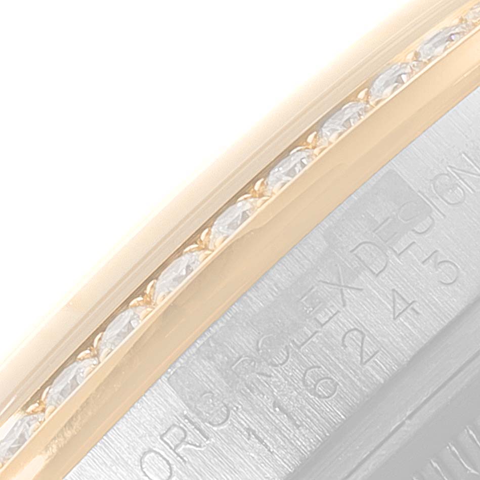 This close-up image shows the bezel, adorned with diamonds, and part of the case of a Rolex Datejust 116243 Men's Steel and Gold (two tone) Silver Dial 116243 Men's Steel and Gold (two tone) Silver Dial watch.