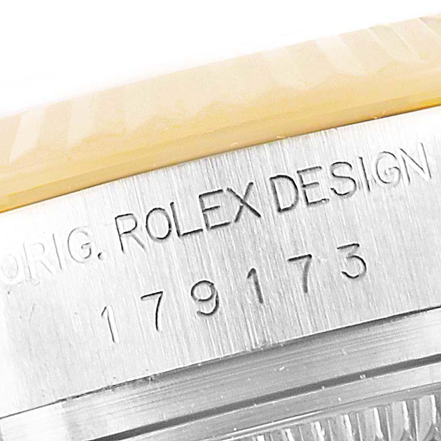 This close-up image shows the engraved case side of a Rolex Datejust 179173 Women's Steel and Gold (two tone) Mother of Pearl Dial 179173 Women's Steel and Gold (two tone) Mother of Pearl Dial, highlighting its model number and "Rolex Design" text.