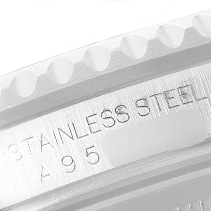 The image shows an angled close-up of the bezel and engraved side case of a Rolex GMT-Master 16710 Men
s Stainless Steel Black Dial 16710 Men
s Stainless Steel Black Dial watch.