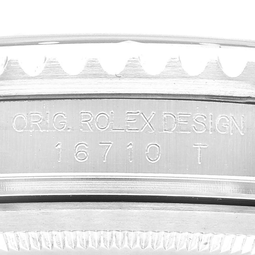 The image shows a close-up of the engraving on the side of a Rolex GMT-Master 16710 Men's Stainless Steel Black Dial 16710 Men's Stainless Steel Black Dial model 16710 T watch case.