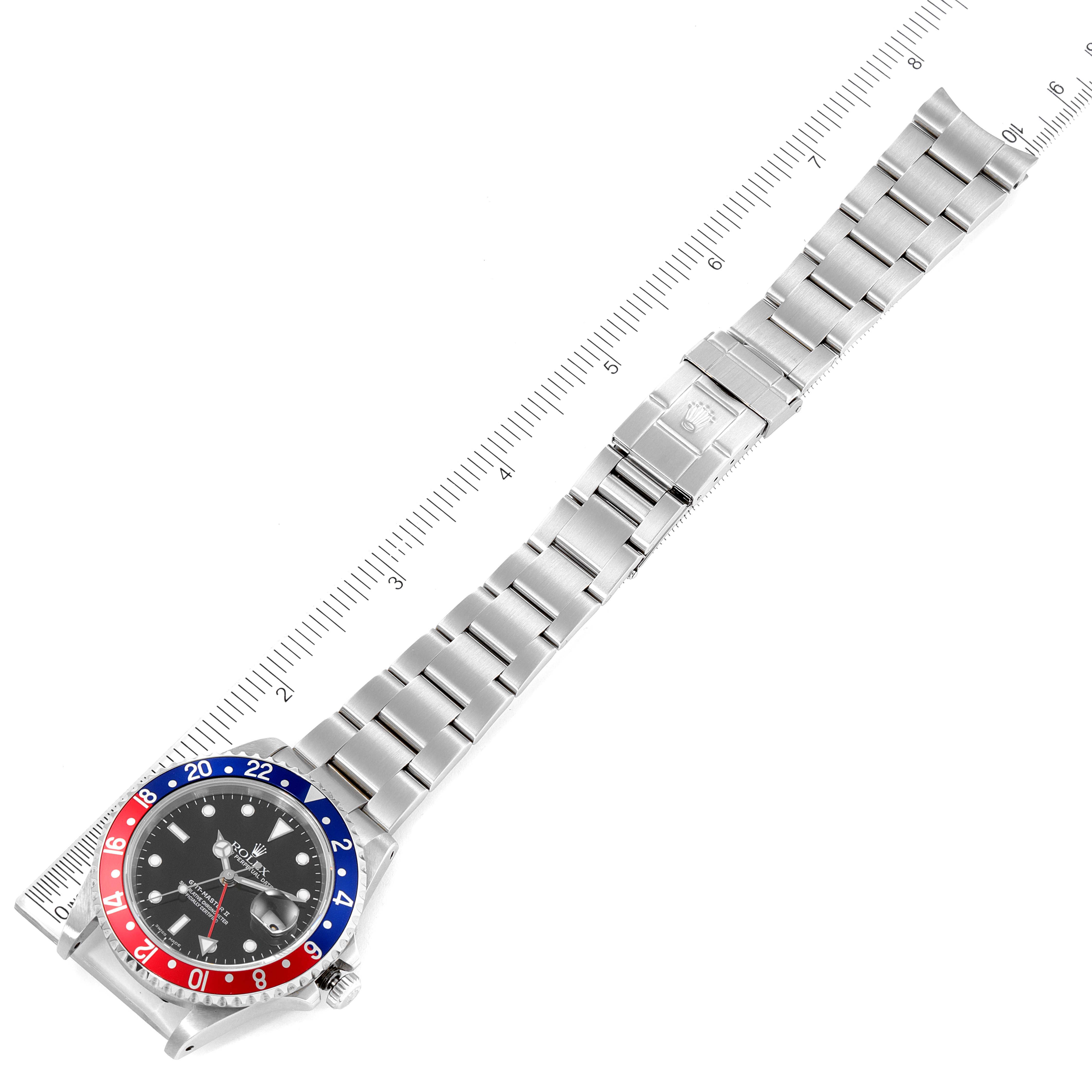 The image shows a top-down view of a Rolex GMT-Master 16710 Men
s Stainless Steel Black Dial 16710 Men
s Stainless Steel Black Dial watch, highlighting its bezel, dial, and full metal bracelet with a clasp.