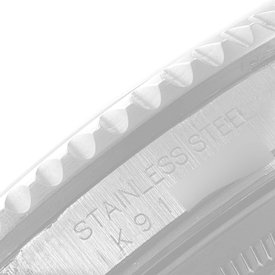The image shows a close-up of the side case and bezel edge of a Rolex GMT-Master 16710 Men
s Stainless Steel Black Dial 16710 Men
s Stainless Steel Black Dial, highlighting the "STAINLESS STEEL" engraving.