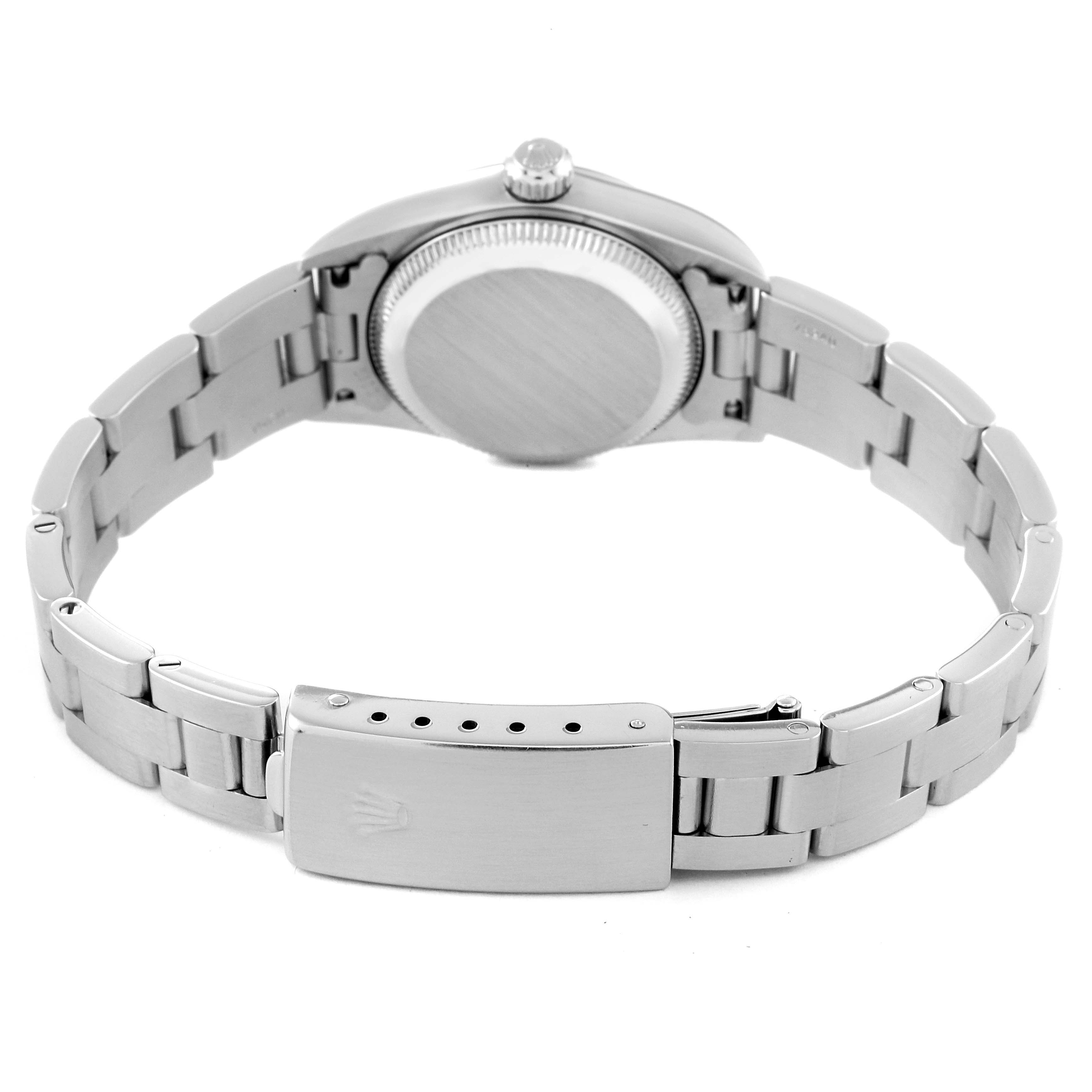 The image shows the back view of an Oyster Perpetual Rolex watch, focusing on the caseback, bracelet, and clasp.