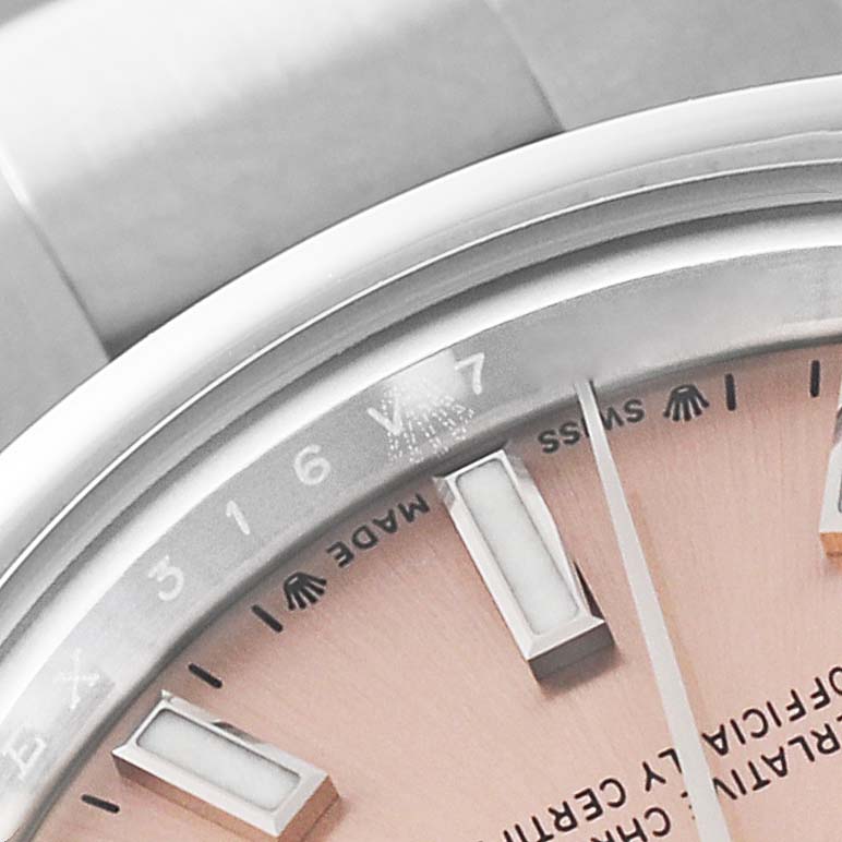This close-up image of a Rolex Oyster Perpetual 276200 Women's Stainless Steel Pink Dial 276200 Women's Stainless Steel Pink Dial watch shows part of the dial, bezel, and bracelet.