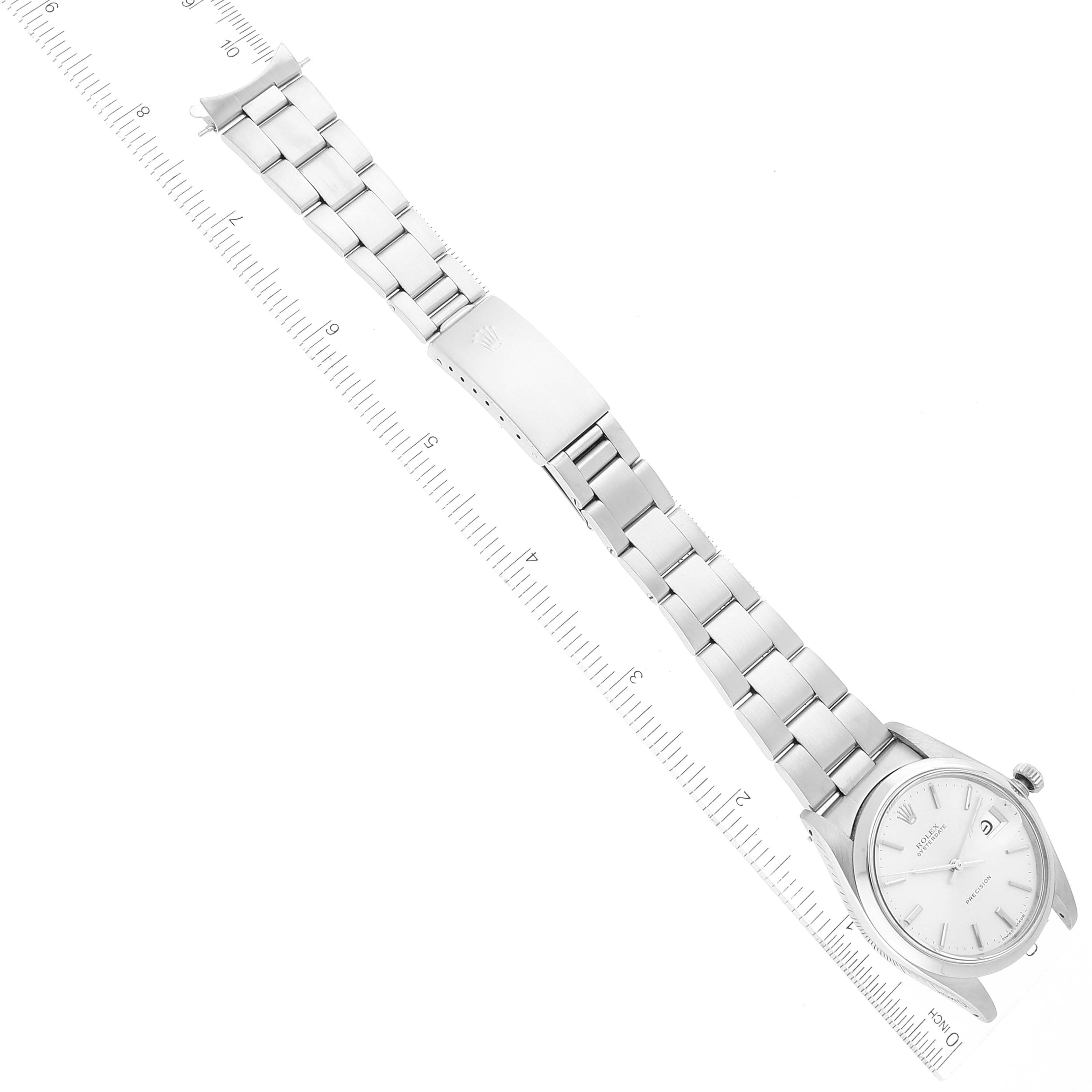 The image shows a top-down view of a Vintage Collection Rolex watch, featuring the dial, bracelet, and clasp.