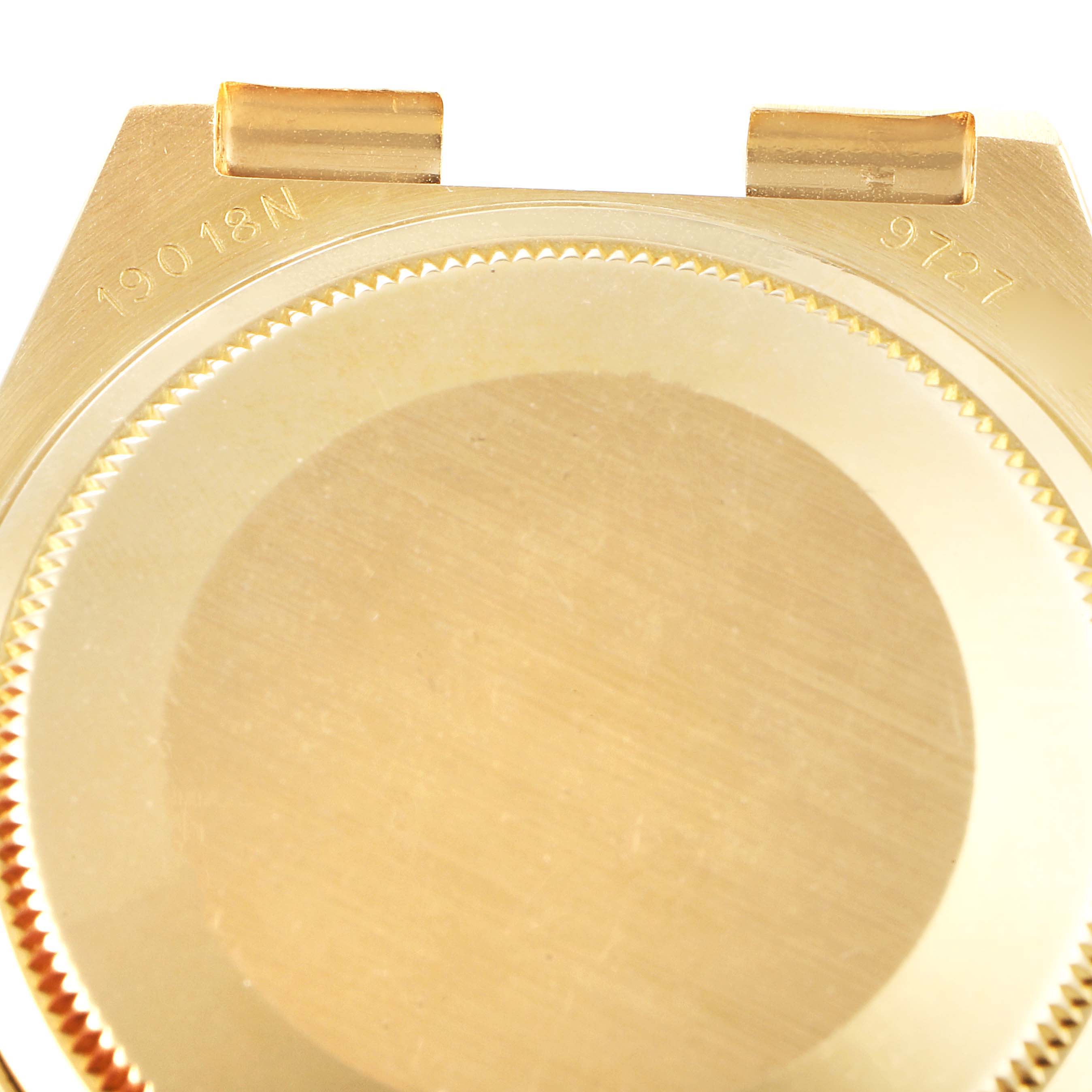 The image shows the back case of a Rolex Oysterquartz 19018 Men's Yellow Gold Champagne Dial 19018 Men's Yellow Gold Champagne Dial watch, focusing on the serial numbers engraved at the top.