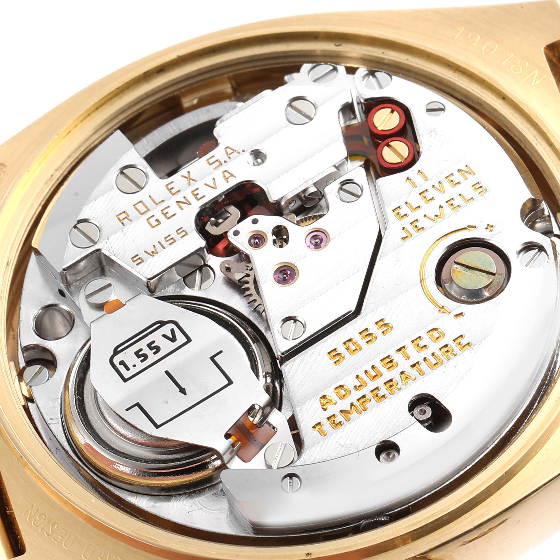 The image shows the inner mechanism of the Rolex Oysterquartz 19018 Men's Yellow Gold Champagne Dial 19018 Men's Yellow Gold Champagne Dial watch, highlighting the intricate components and the battery.