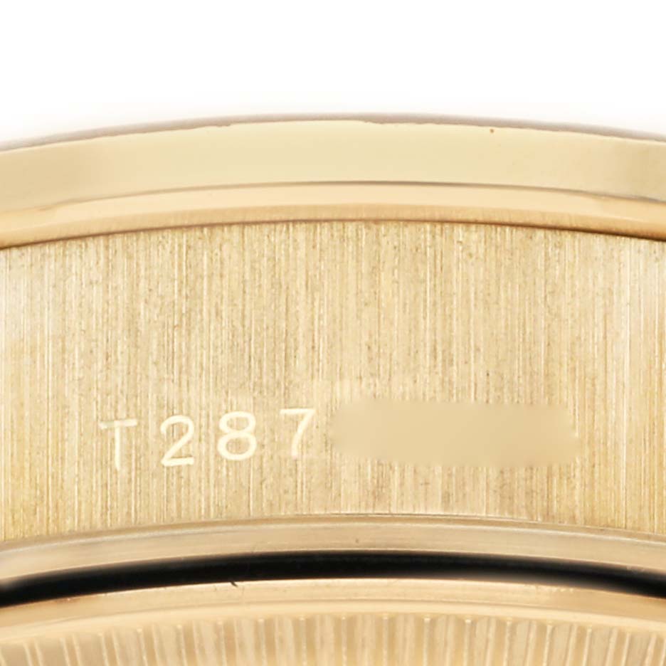 This close-up image shows the engraved serial number on the side of a Rolex President 69288 Women's Yellow Gold Champagne Dial 69288 Women's Yellow Gold Champagne Dial model watch.