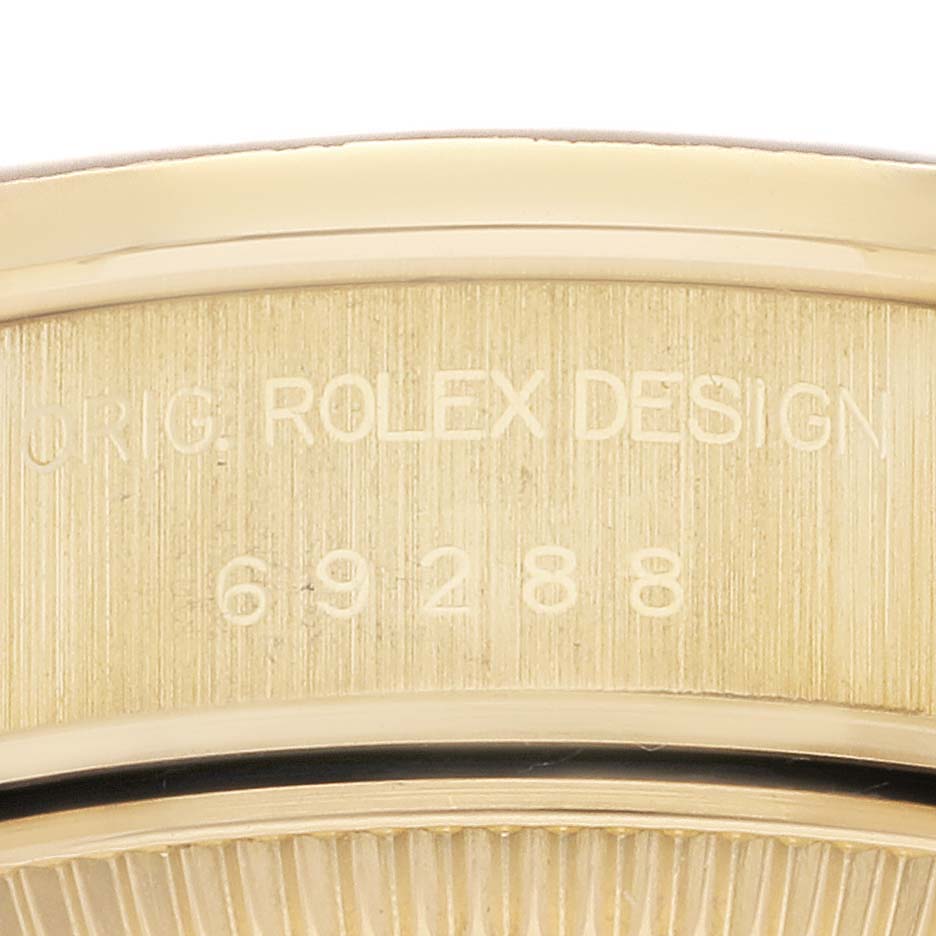 This image shows a close-up of the side of a Rolex President 69288 Women's Yellow Gold Champagne Dial 69288 Women's Yellow Gold Champagne Dial model, highlighting its case engraving.
