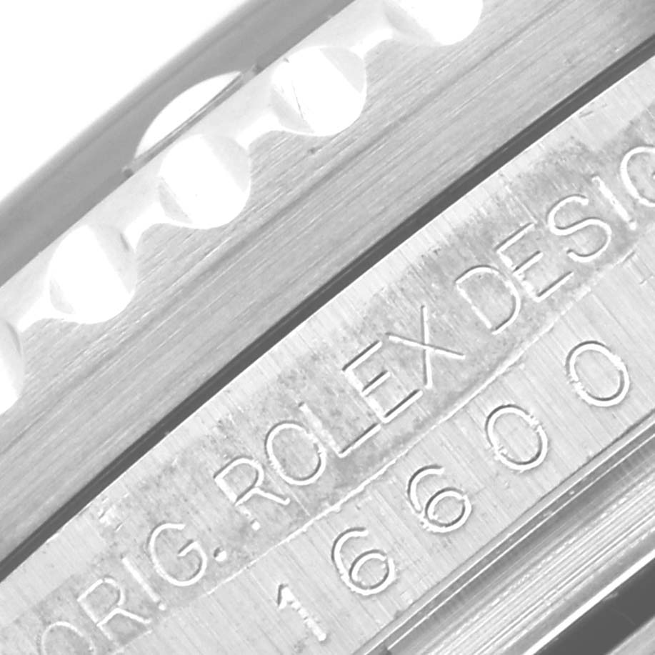The image shows a close-up of the engravings and bezel edge of a Rolex Sea-Dweller 16600 Men's Stainless Steel Black Dial 16600 Men's Stainless Steel Black Dial watch.