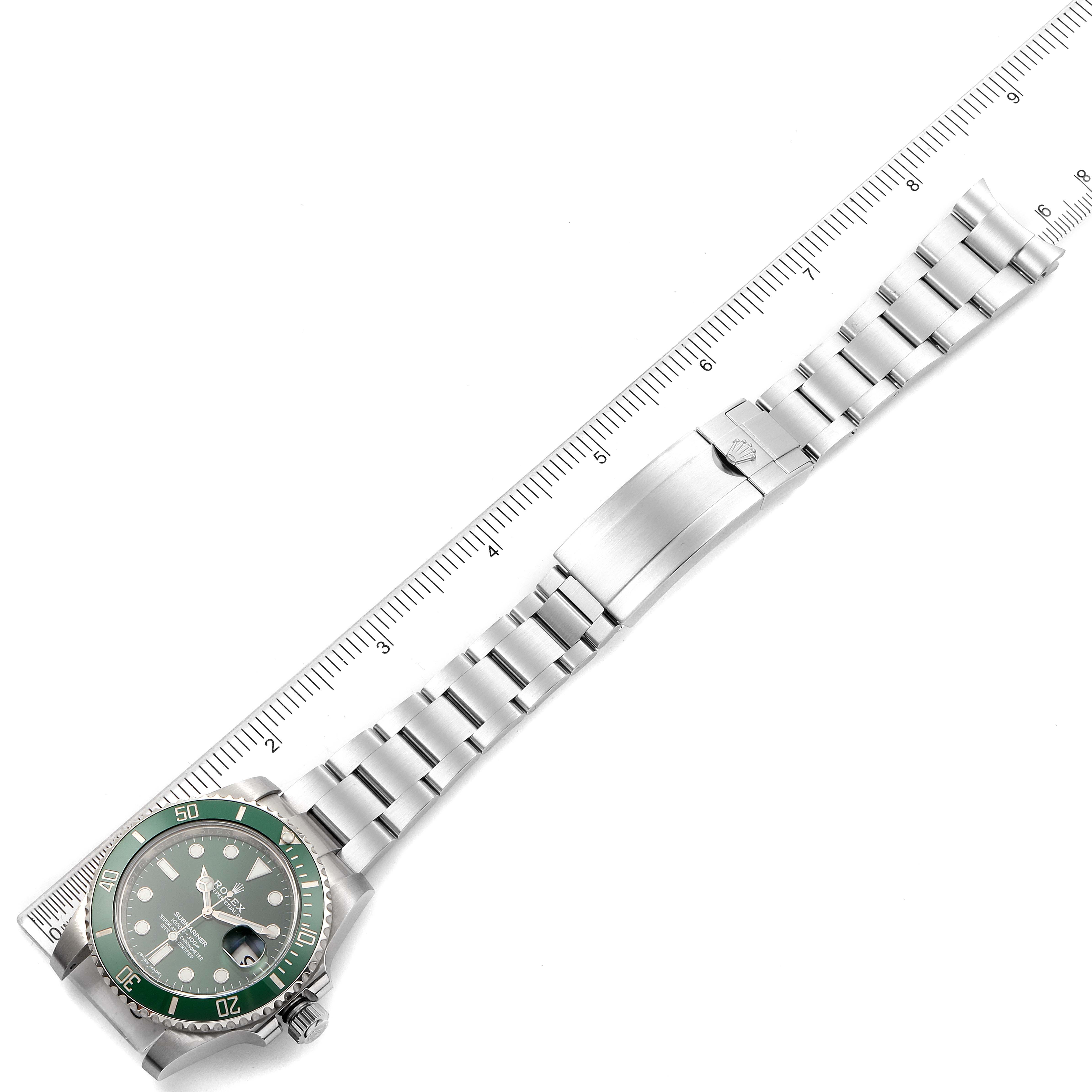 The Rolex Submariner 116610LV Men's Stainless Steel Green Dial 116610LV Men's Stainless Steel Green Dial watch is shown from an overhead angle, displaying the entire watch and its metal bracelet fully extended.