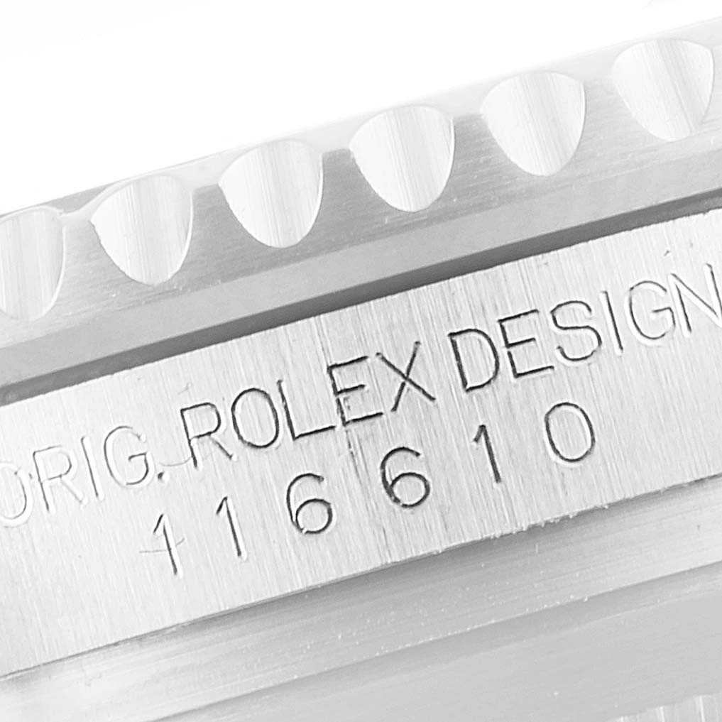 The image shows a close-up of the engraved bezel and case of a Rolex Submariner 116610LV Men's Stainless Steel Green Dial 116610LV Men's Stainless Steel Green Dial model 116610.