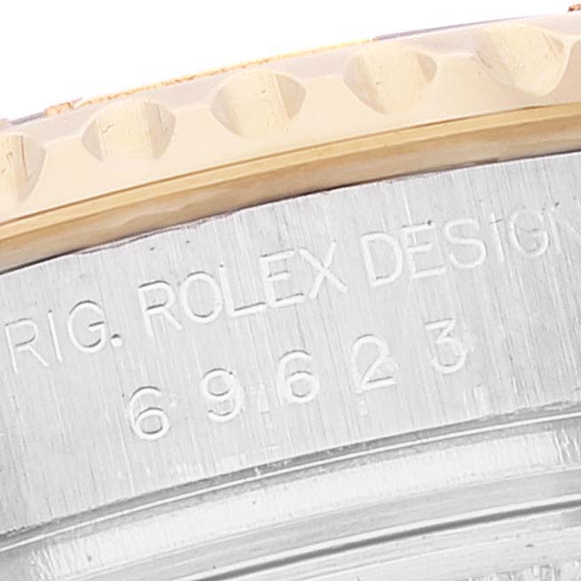The image shows a close-up of the side engraving and bezel of a Rolex Yacht-Master 69623 Women's Steel and Gold (two tone) Blue Dial 69623 Women's Steel and Gold (two tone) Blue Dial watch.