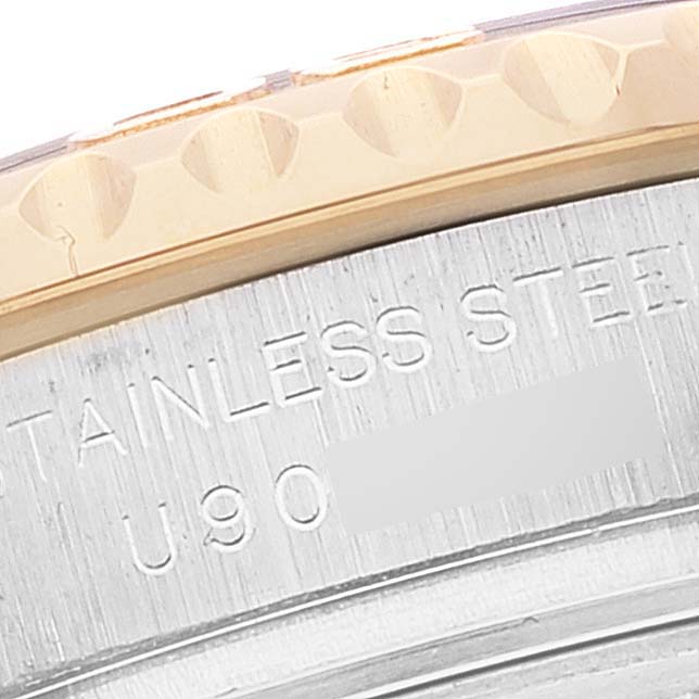 This image shows a close-up of the side engraving and part of the bezel of a Rolex Yacht-Master 69623 Women's Steel and Gold (two tone) Blue Dial 69623 Women's Steel and Gold (two tone) Blue Dial watch.
