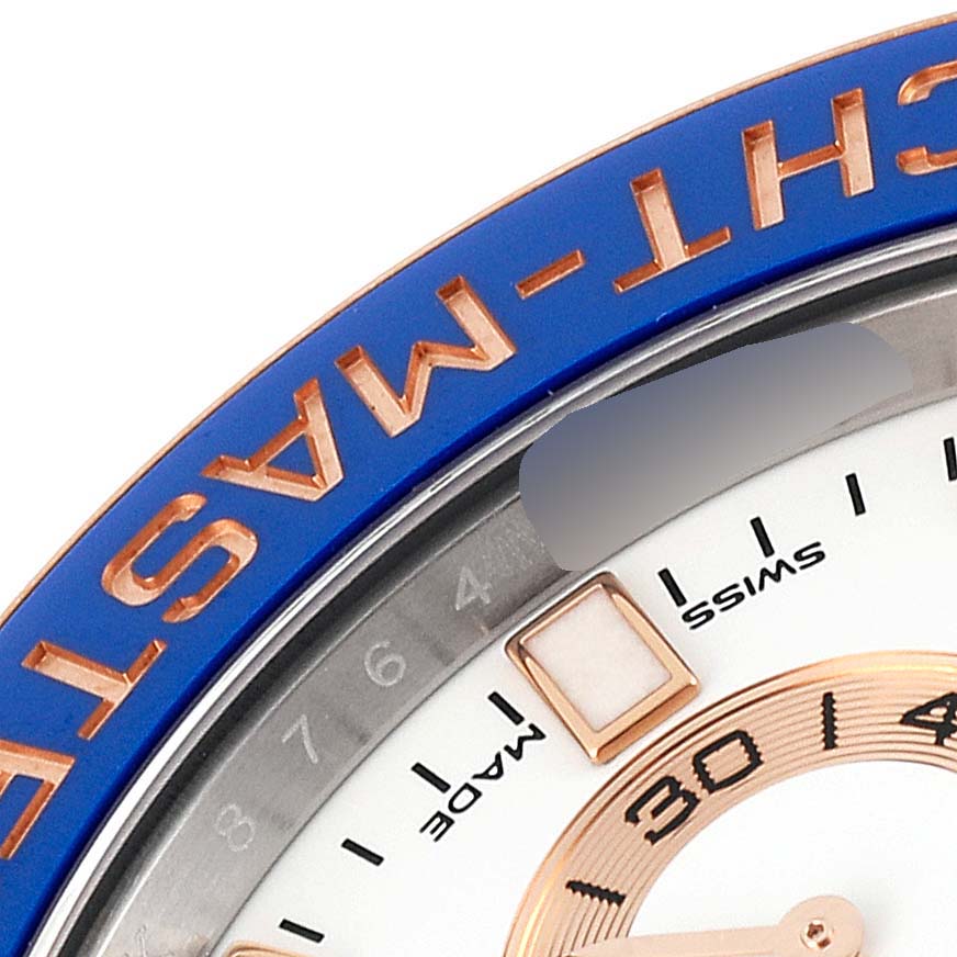 This image shows a close-up of the bezel and part of the dial of a Rolex Yacht-Master 116681 Men
s Steel and Gold (two tone) White Dial 116681 Men
s Steel and Gold (two tone) White Dial watch.