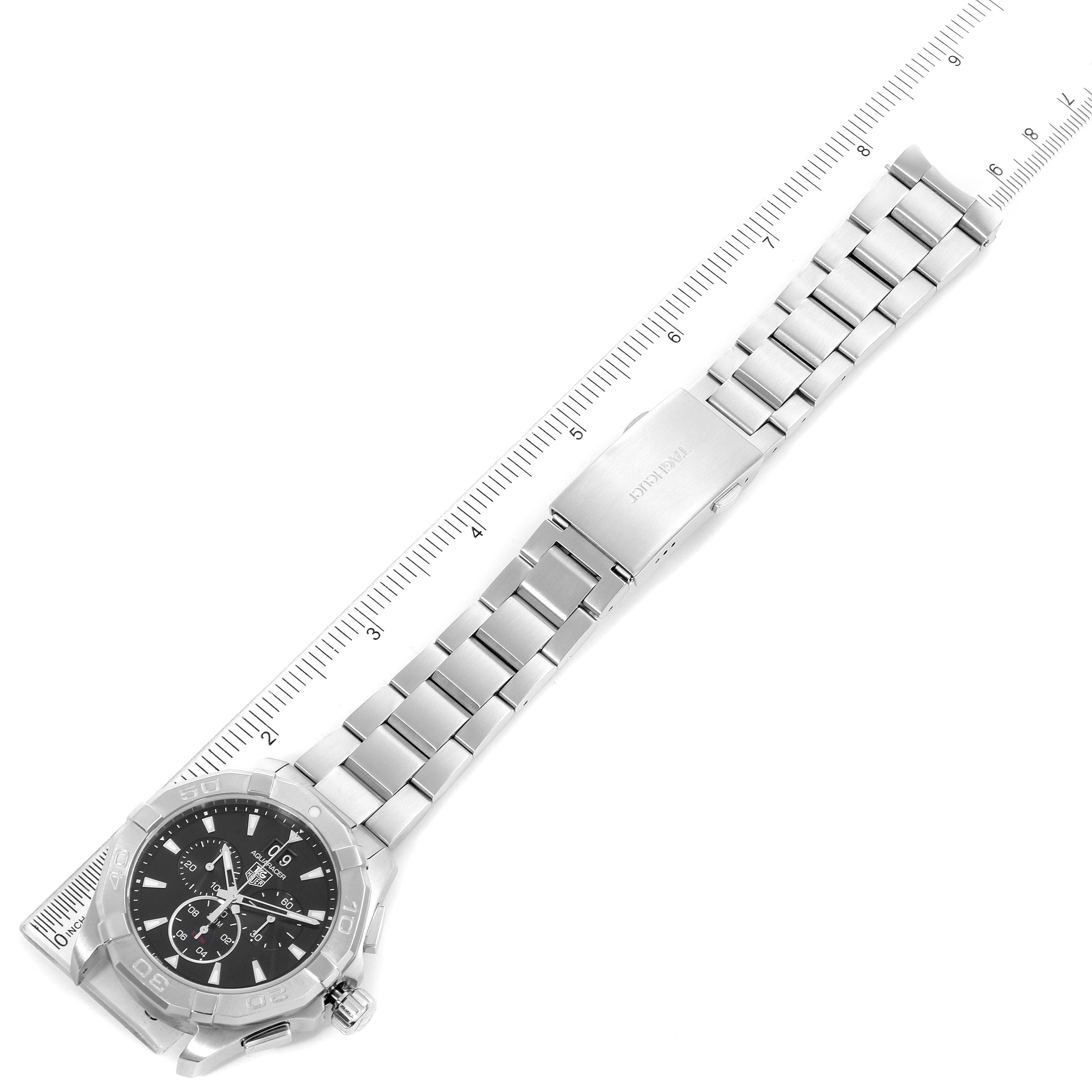 The image shows a Tag Heuer Aquaracer CAY1110.BA0927 Men
s Stainless Steel Black Dial CAY1110.BA0927 Men
s Stainless Steel Black Dial watch positioned flat with its face, bezel, bracelet, and clasp visible, alongside a measurement ruler.