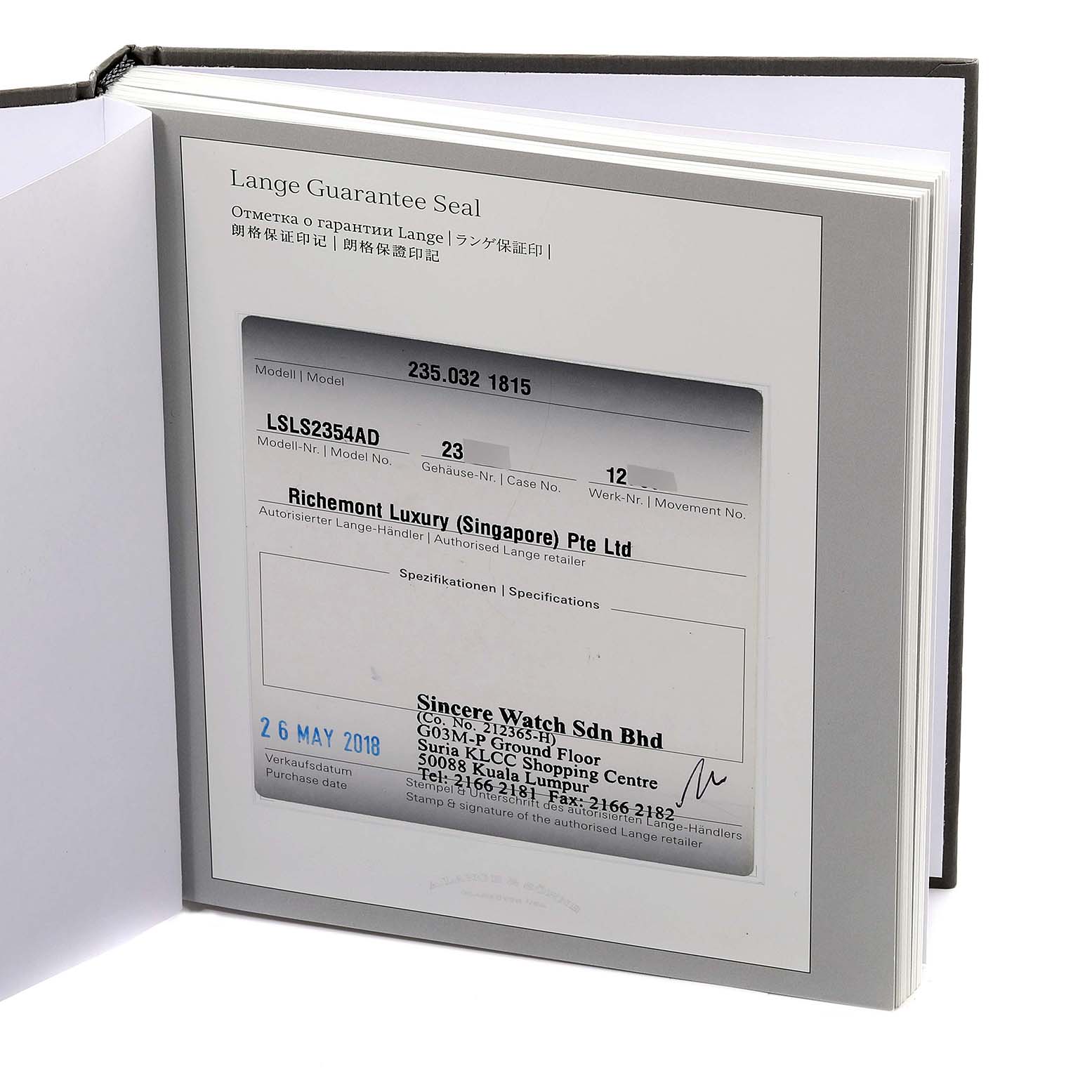 This image shows an open booklet with the guarantee certificate for the 1815 model by A. Lange & Sohne, viewed from an angled perspective.