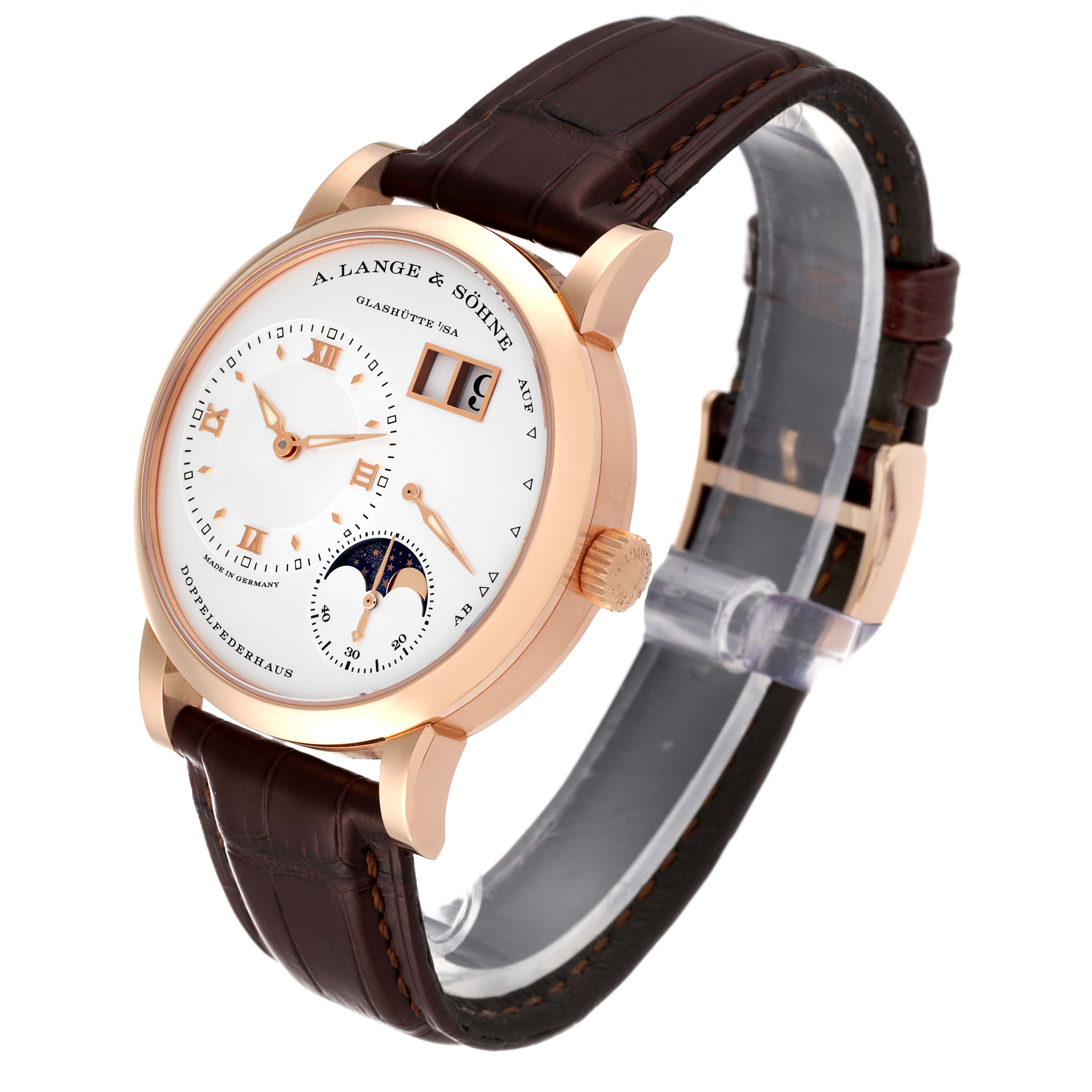 The image shows a side-angle view of the Lange 1 model by A. Lange & Söhne, highlighting its dial, strap, and buckle.