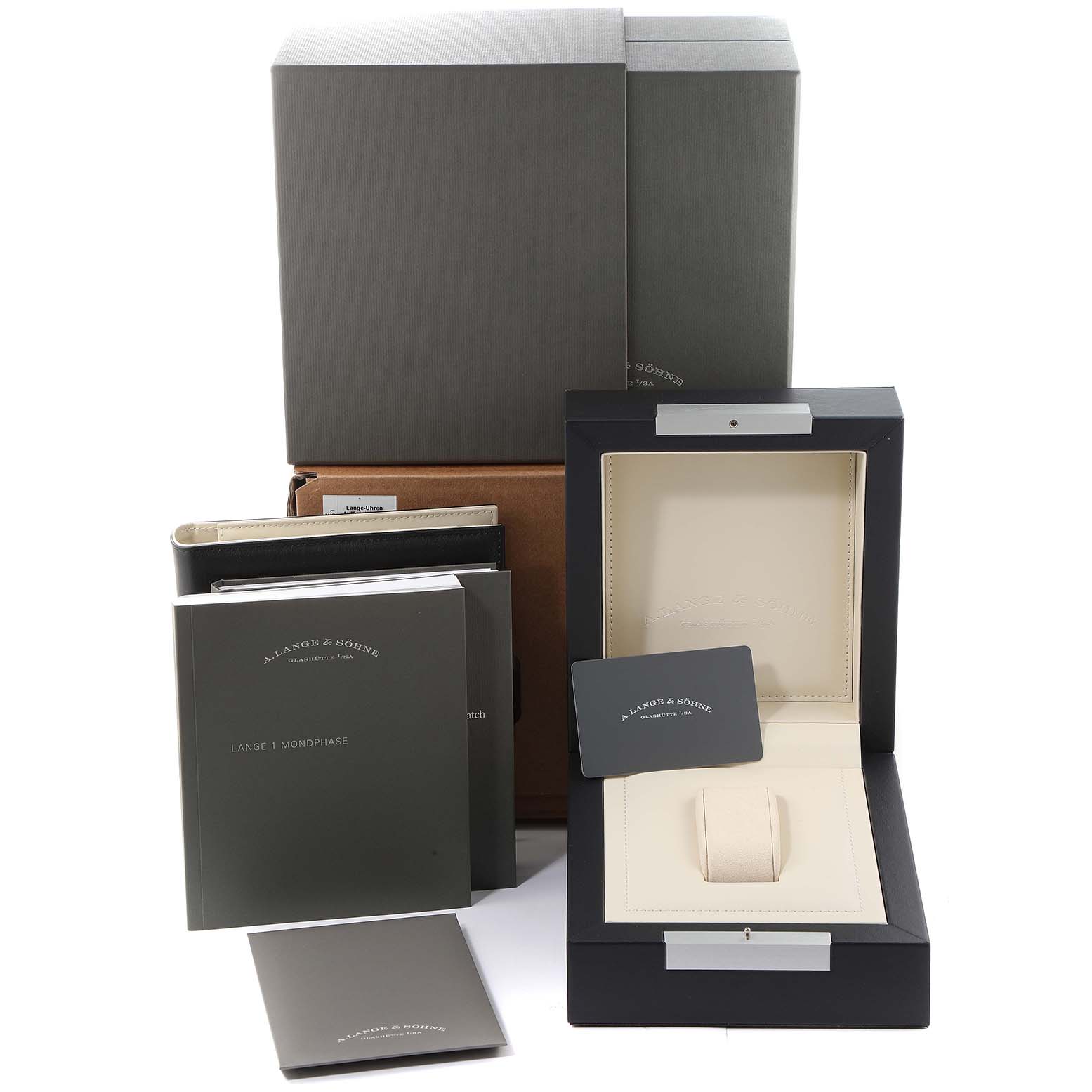 The image shows packaging, manuals, and the display box for the A. Lange & Sohne Lange 1 model watch.