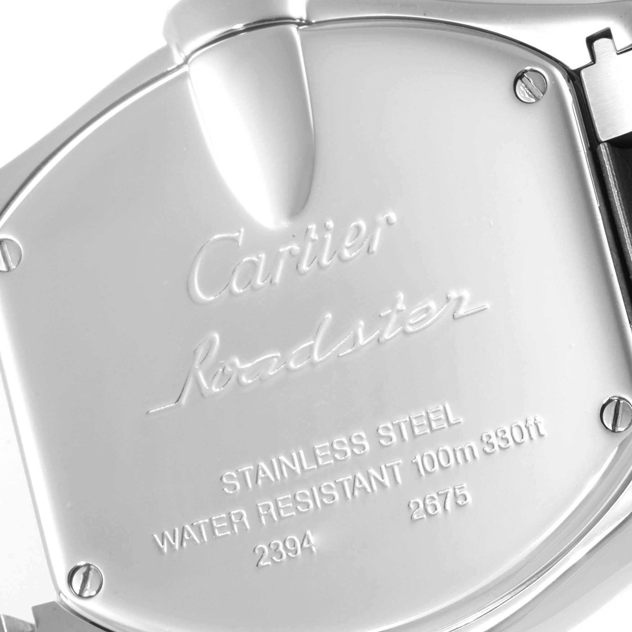 The image shows a close-up view of the back case of a Cartier Roadster W62016V3 Women's Stainless Steel Silver Dial W62016V3 Women's Stainless Steel Silver Dial watch, highlighting its engravings and screws.