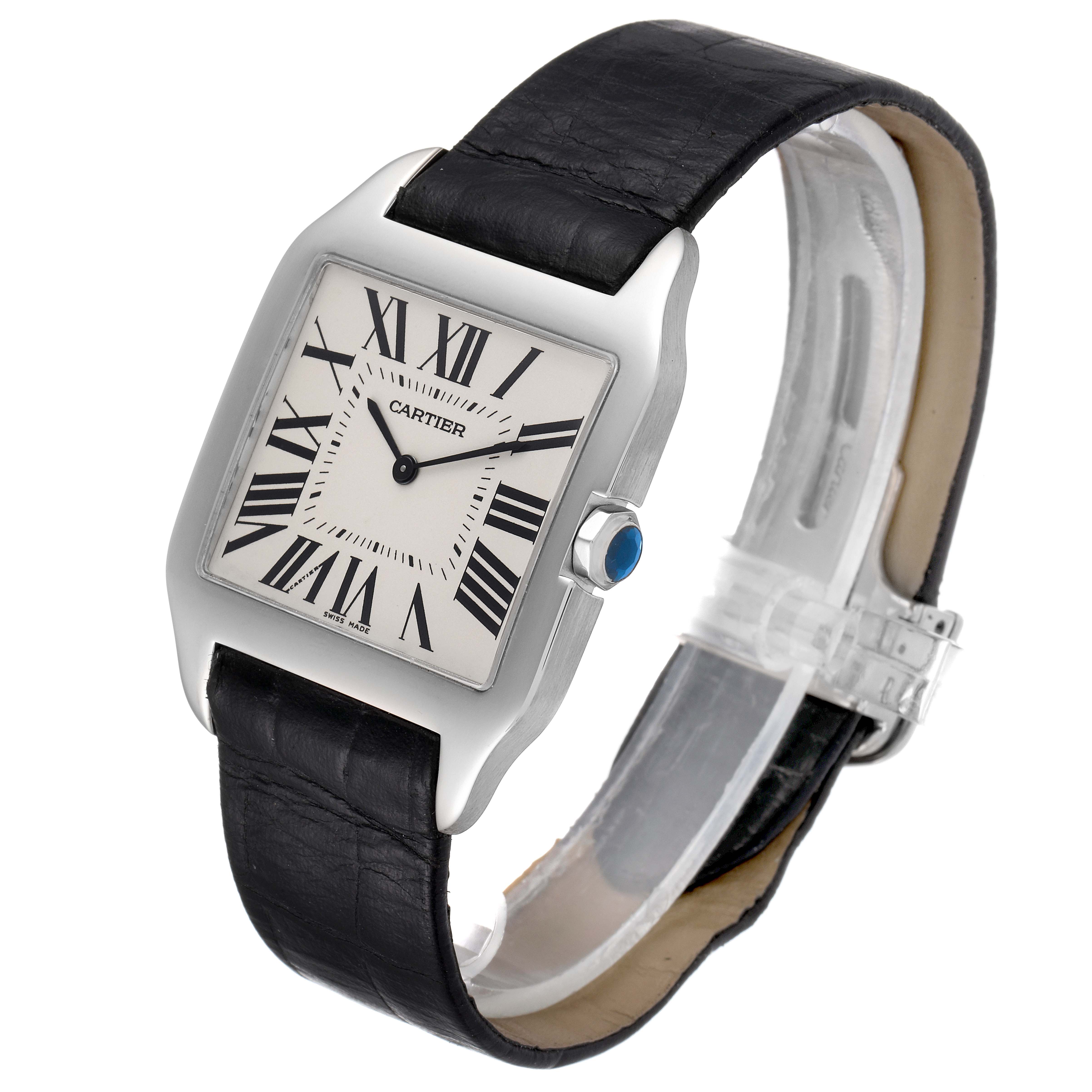 The image shows a Cartier Santos Dumont W2007051 Men's White Gold Silver Dial W2007051 Men's White Gold Silver Dial watch angled to display its face, black leather strap, and silver case with a blue gem crown.