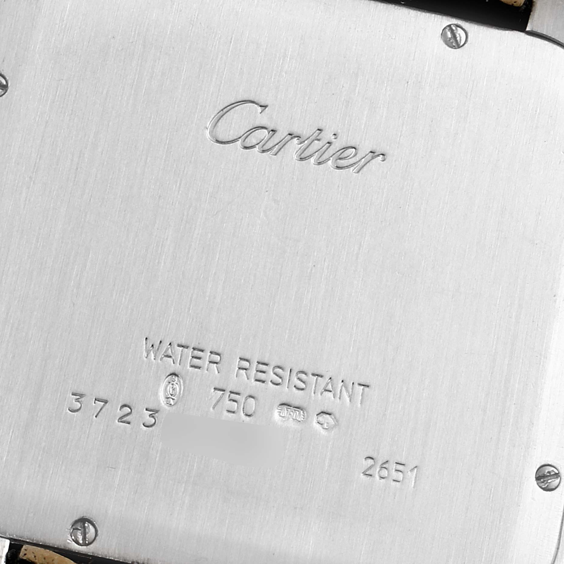 The image shows the back casing of a Cartier Santos Dumont W2007051 Men's White Gold Silver Dial W2007051 Men's White Gold Silver Dial watch, highlighting its inscriptions and markings.