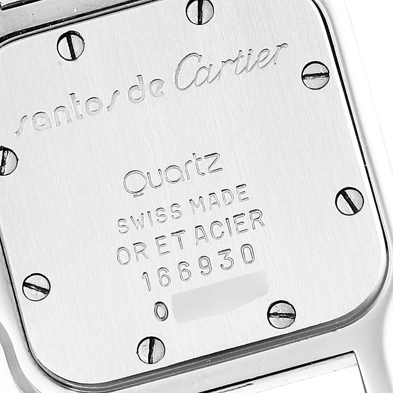 This image shows the back case of the Santos model by Cartier, highlighting the brand engraving and serial number.